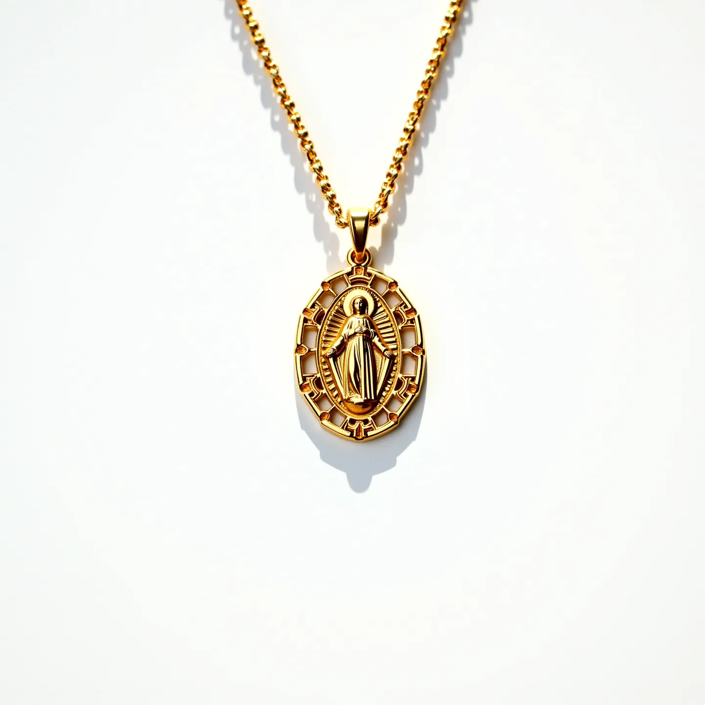 This Virgin Mary necklace features a beautifully crafted gold-toned chain with a pendant that showcases an intricate depiction of the Virgin Mary. The pendant is oval-shaped, with a delicate lattice pattern encircling the figure, highlighting the detailed artistry of the design. The chain appears to be of medium thickness, likely made of gold or a gold-plated material, providing a harmonious overall appearance. The clasp is not visible in the image, suggesting a continuous chain or possibly a small, unobtrusive fastening. No gems or stones are present in the necklace, emphasizing the metallic sheen and simplicity of the piece.