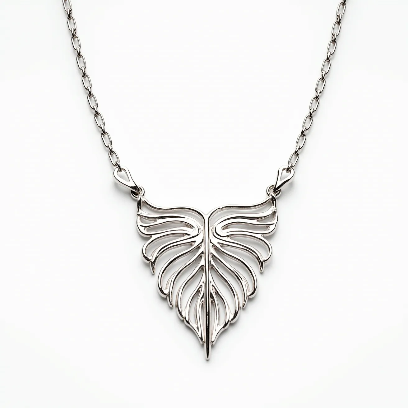 This white gold necklace features a delicate chain linked to an ornate pendant with a stylized leaf design. The pendant showcases intricate openwork that allows light to pass through, highlighting the craftsmanship of the piece. The necklace is secured with a subtle and secure clasp, ensuring it sits comfortably around the neck. The choice of white gold complements the refined and elegant design, making it a versatile accessory for various occasions.