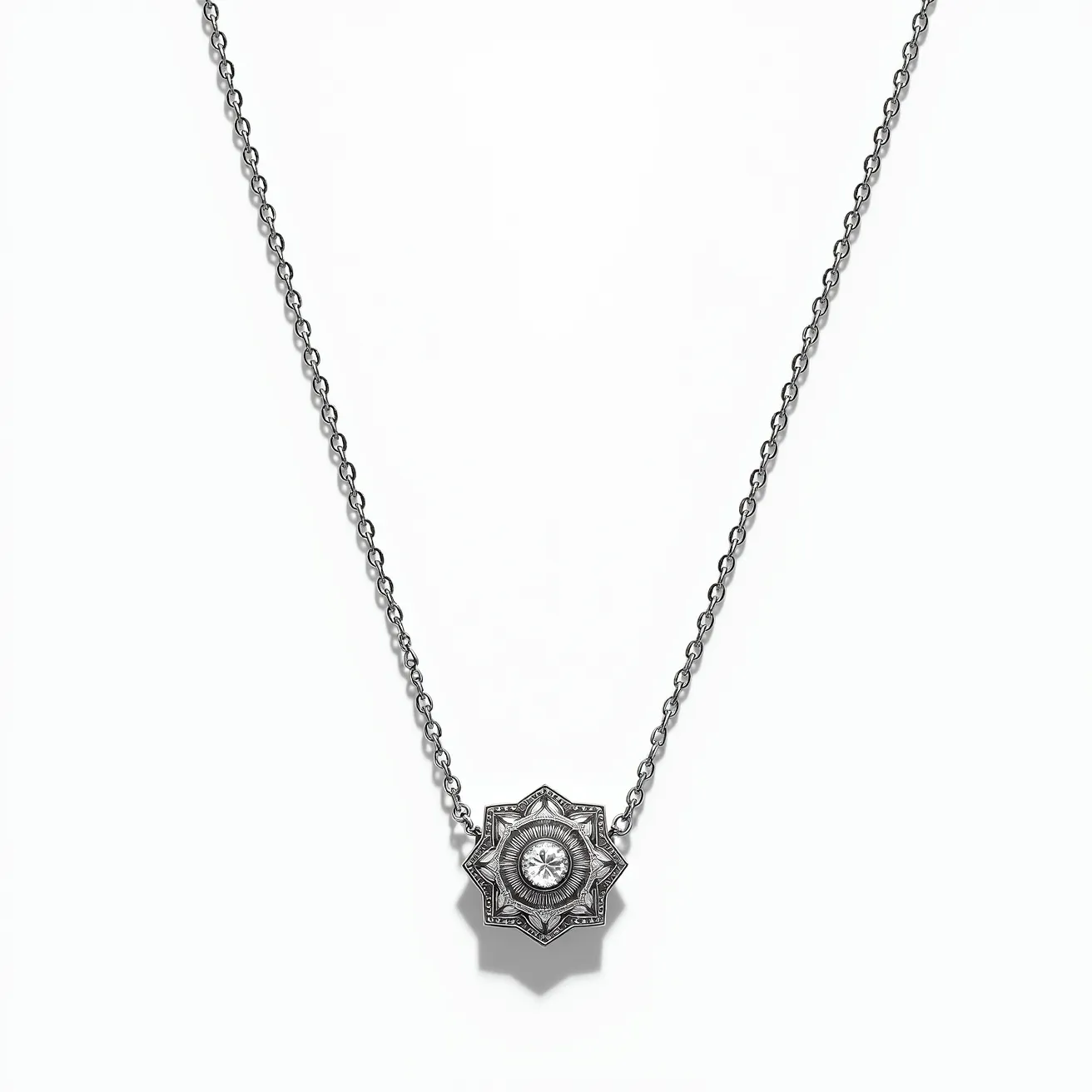 This white gold necklace features a delicate chain that leads to a central pendant shaped like an intricate star. At the heart of the pendant is a round-cut diamond, securely set in a bezel setting. The surrounding star patterns add an element of detailed craftsmanship, enhancing the necklace's elegance. The chain appears to be finely linked, providing both strength and a smooth texture. The necklace is likely fastened with a standard spring ring clasp, providing a reliable attachment.