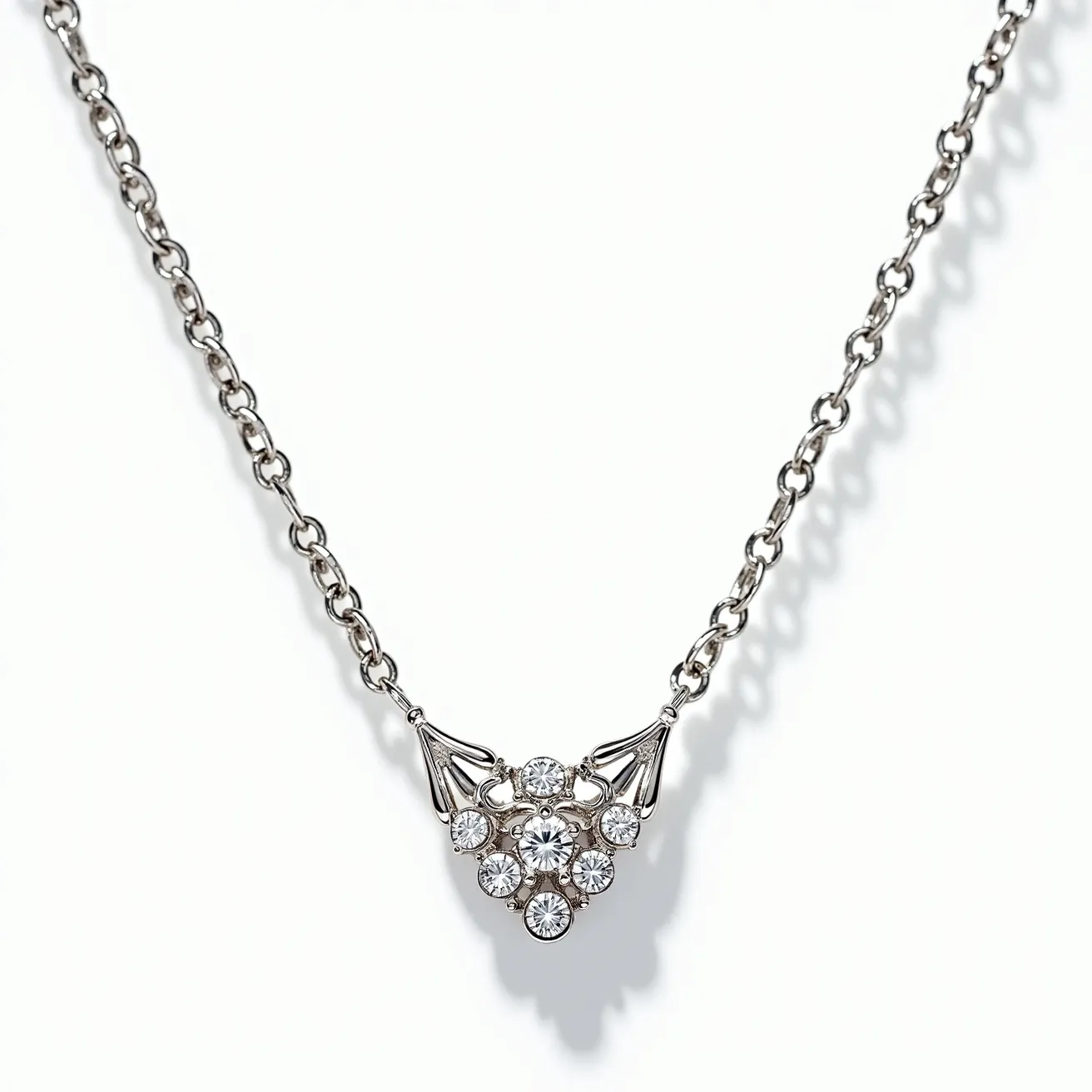 This white sapphire necklace features a delicate silver chain that supports a central pendant adorned with sparkling white sapphires. The gemstones are round-cut and arranged in a symmetrical floral pattern, with a slightly larger sapphire at the center, creating an elegant focal point. The sapphires are set in a prong setting, allowing maximum light to pass through and enhance their brilliance. The necklace likely includes a simple clasp for secure attachment, complementing the overall minimalist yet sophisticated design.