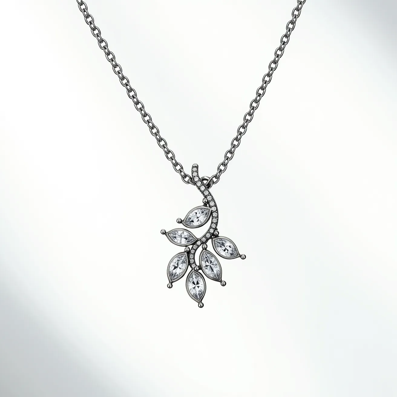 This white sapphire necklace features a delicate design, with sparkling marquise-cut white sapphire stones intricately set in a vine-like arrangement. Each stone is securely held in place with prong settings, enhancing their brilliance and clarity. The pendant elegantly dangles from a fine, polished chain, which is likely made from a material such as sterling silver or white gold, providing a sleek and sophisticated backdrop for the stones. The chain appears to secure with a simple but sturdy clasp, ensuring it stays fastened securely when worn. The careful craftsmanship highlights the timeless beauty and elegance of the white sapphires, making this necklace a stunning piece of jewelry.