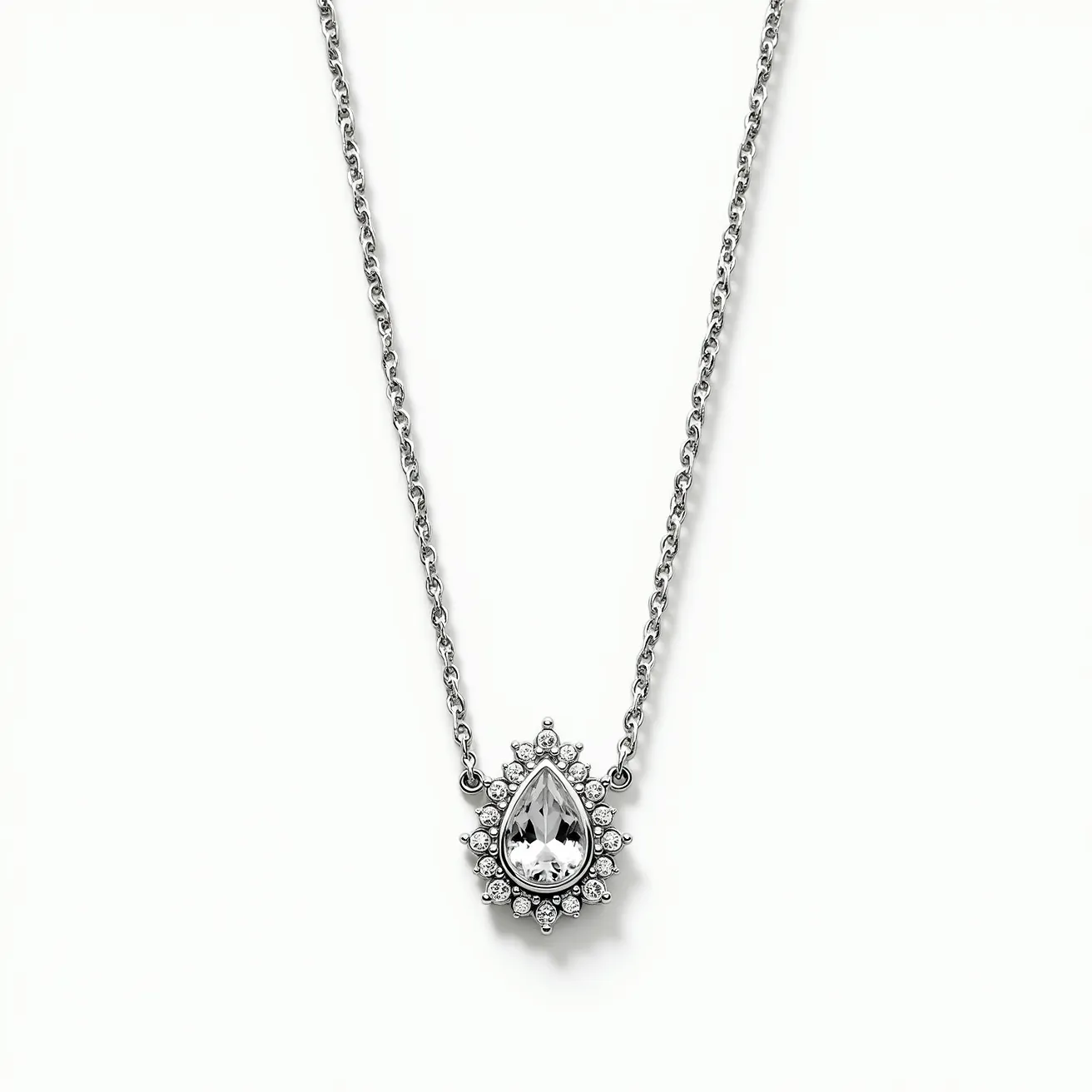 This white sapphire necklace features a delicate chain, likely made of silver or white gold, adding a sleek, polished appearance. The pendant showcases a pear-shaped white sapphire, expertly cut to enhance its brilliance and clarity. Surrounding the central gem are smaller round-cut stones, possibly diamonds or cubic zirconia, arranged in a halo setting that accentuates the necklace's elegance and opulence. The pendant is securely attached to the chain with precise metalwork, ensuring durability and style. The clasp is likely a standard lobster style, offering ease of use and security.