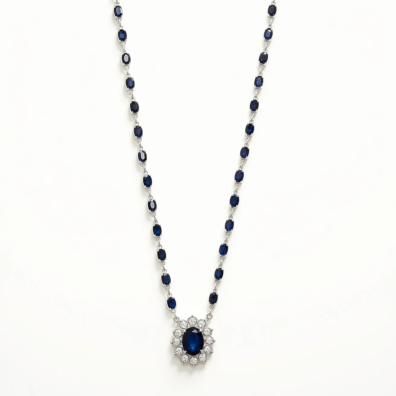 This white sapphire necklace features a striking arrangement of deep blue stones, likely sapphires, set in a pattern of alternating links, each surrounded by a delicate metal setting that may be silver or white gold. The necklace culminates in a prominent pendant, showcasing an oval-cut central sapphire encircled by a halo of white sapphires or diamonds, accentuating the central gem's rich color. The stones are securely set in prongs that highlight their luster and shape. The necklace likely closes with a discreet, secure clasp that complements its elegant design, ensuring both beauty and functionality.