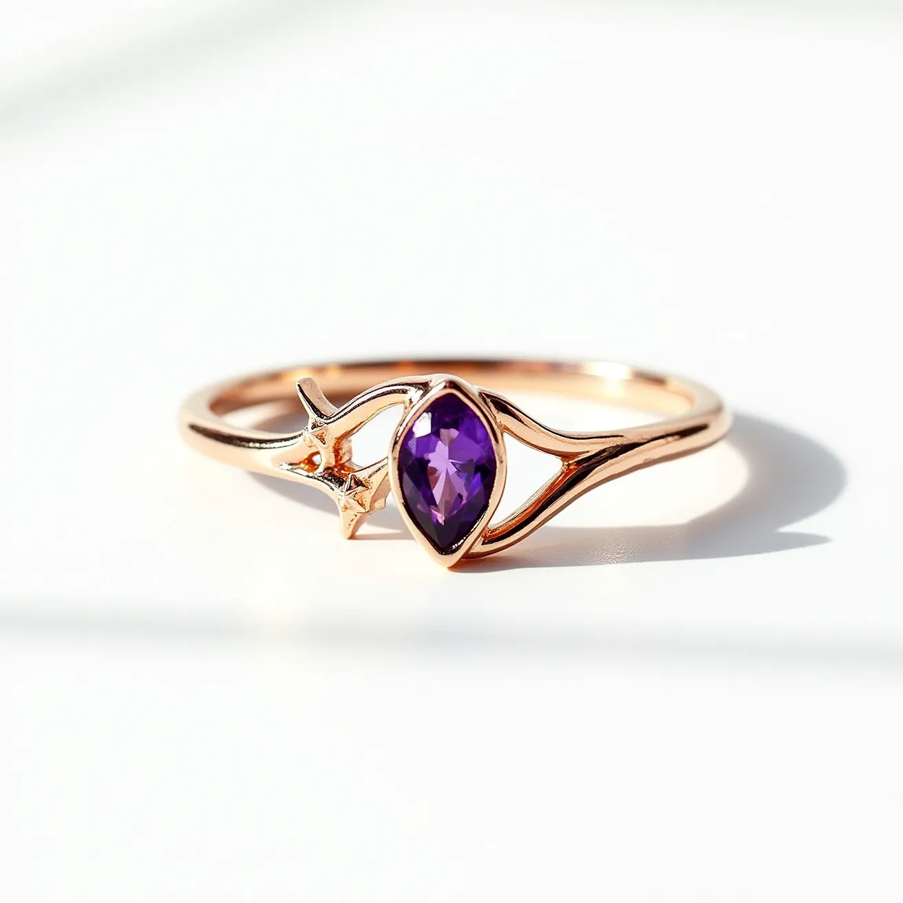 This amethyst promise ring features a marquise-cut amethyst set at the center, enhancing its deep purple hue. The stone is securely held in a bezel setting, providing a smooth and protective encasement. The band material appears to be a polished rose gold, complementing the gem's color with a warm, luxurious finish. The design includes a delicate star motif near the stone, adding an artistic element that elevates the ring’s overall aesthetic appeal. There is no visible clasp or attachment, indicating a traditional circular band structure, ideal for a promise or commitment jewelry piece.