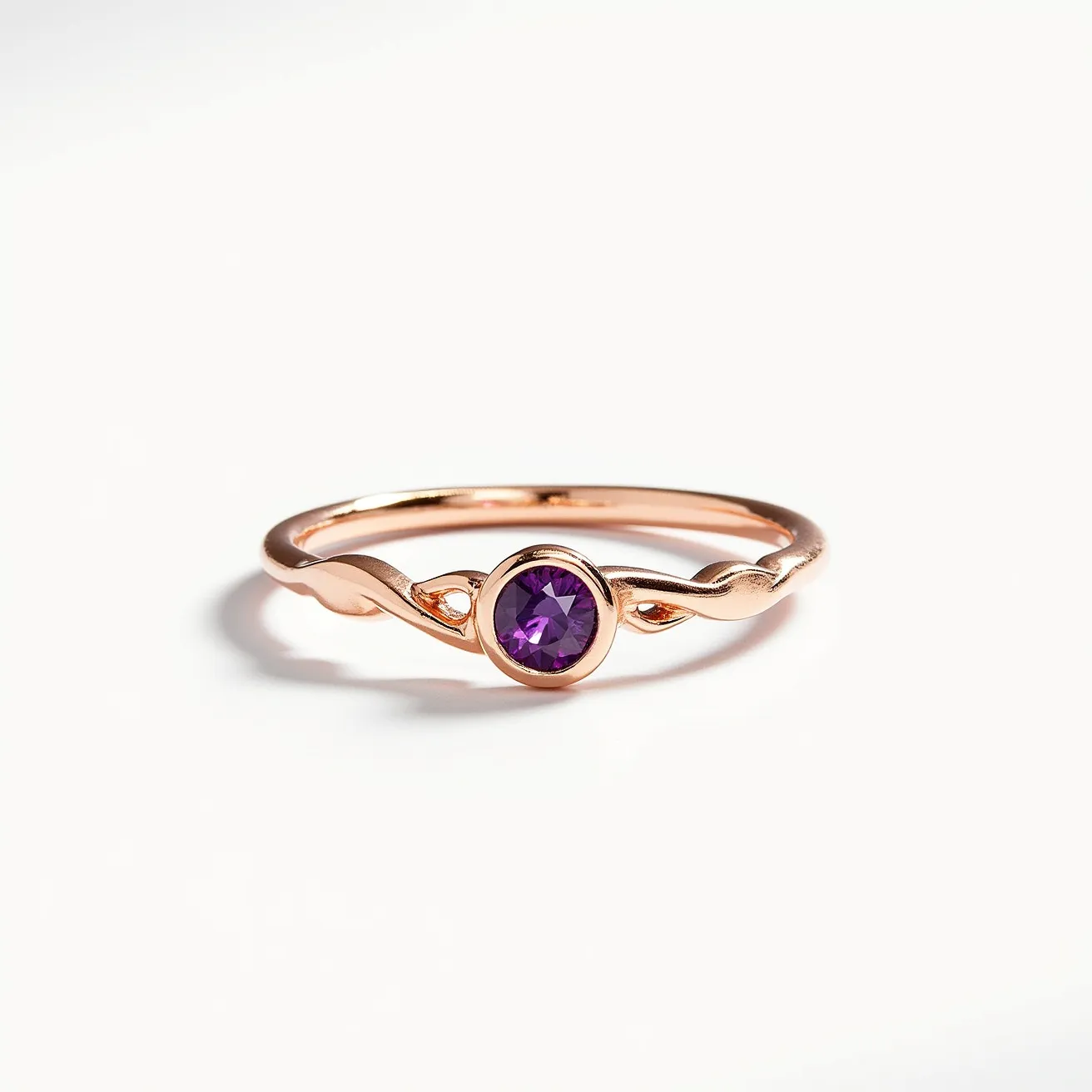 This amethyst promise ring features a delicate design crafted from a rose gold band, which exhibits a twisting motif that elegantly encapsulates a single, round-cut amethyst in a bezel setting. The vibrant purple of the amethyst offers a striking contrast to the warm tones of the rose gold, enhancing the ring's visual appeal and symbolizing commitment and sincerity. The simplicity and elegance of the design emphasize the stone's natural beauty, making it an exquisite piece for expressing promises and intentions.