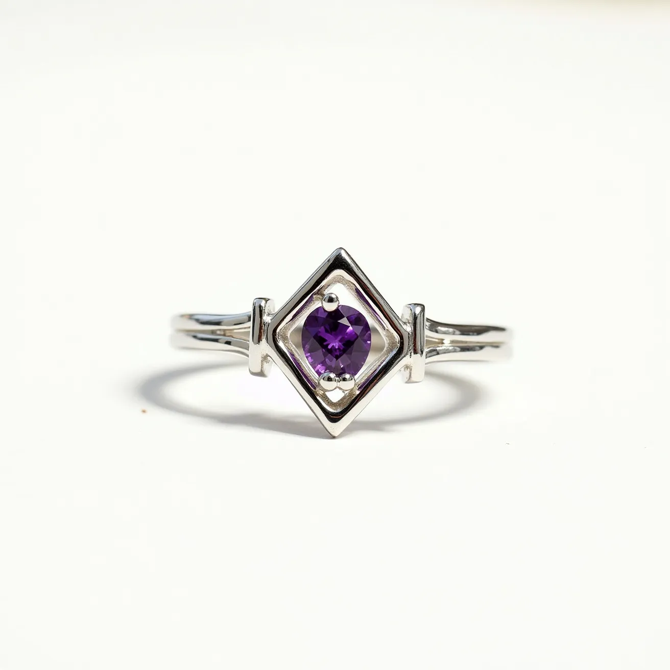 This amethyst promise ring features a striking purple amethyst gemstone at its center, captivating with its faceted cut that enhances its natural brilliance. The stone is elegantly set in a geometric, bezel-style setting, which securely holds the gem while allowing maximum visibility. The ring is crafted from a polished metal, likely silver or white gold, which complements the deep hue of the amethyst. Its band is designed with a split shank style, adding a touch of sophistication and balance to the overall aesthetic. This elegant piece combines modern design with timeless elegance, making it a meaningful symbol of commitment.