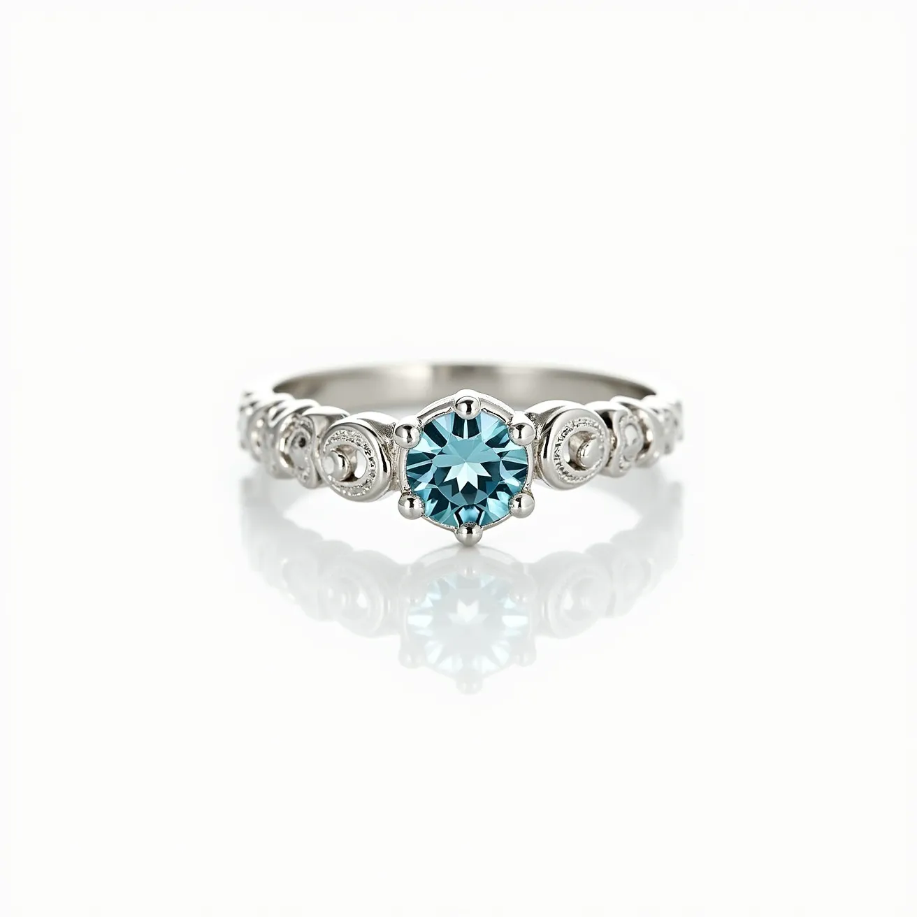 This aquamarine ring features a vibrant, round-cut aquamarine stone at its center, held securely by a sturdy, six-prong setting. The band is crafted from a sleek metallic material, likely white gold or platinum, given its reflective quality and smooth finish. Surrounding the central stone, the band is adorned with intricate scroll or swirl designs, enhancing the overall elegance and vintage appeal of the piece. The ring combines classic elements with a touch of sophisticated detailing, making it a striking accessory.