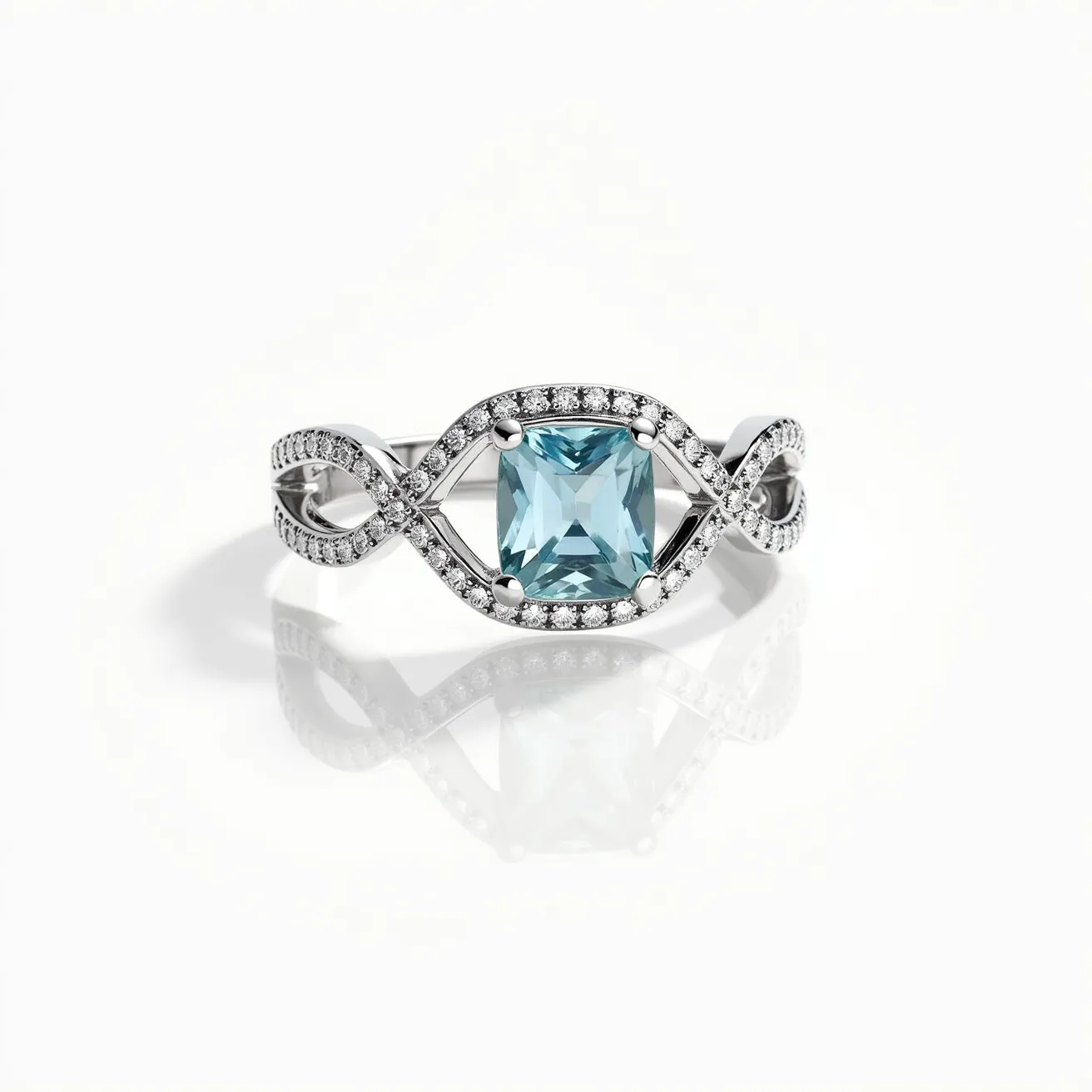 This aquamarine ring features a central square-cut aquamarine gemstone set in a pronged setting. The band is crafted from a silver-toned metal, intricately designed in an infinity motif, which is embellished with small round-cut diamonds or diamond-like stones, adding a sparkling accent to the elegant design. The aquamarine serves as the focal point, contrasting beautifully with the gleaming band and the subtle shimmer of the surrounding stones, creating a harmonious and sophisticated piece of jewelry suitable for various occasions.