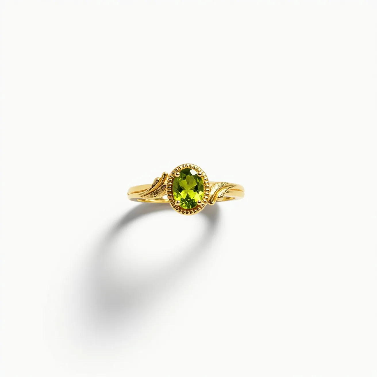 This august birthstone ring features a vibrant oval-cut peridot set in a detailed gold band. The peridot, known for its distinctive green hue, is securely held with a prong setting, enhancing its brilliance and visibility. The band, crafted from polished gold, showcases elegant leaf-like designs on either side of the gemstone, adding to the ring's delicate and sophisticated appearance. This thoughtful design highlights the peridot, making it the focal point of the piece.