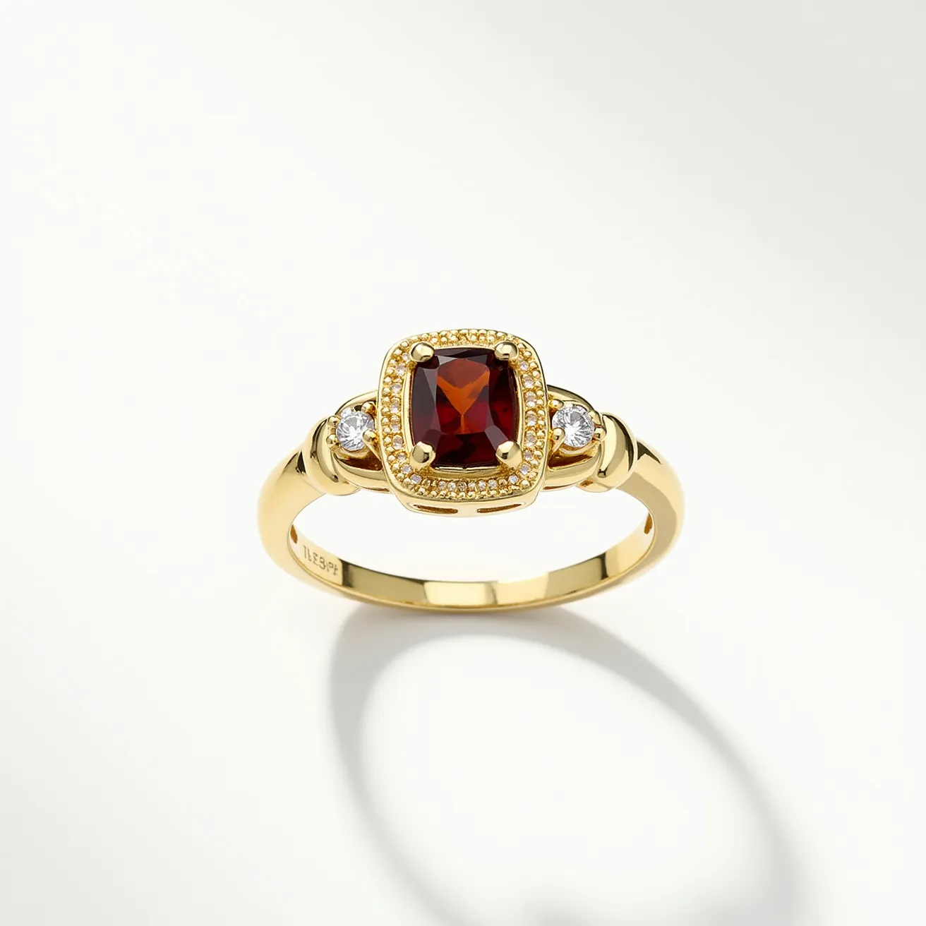 This August birthstone ring showcases a striking design prominently featuring a cushion-cut red gemstone at its center, typically representing a high-quality peridot for the month of August. This central gem is set in a gold band, exuding warmth and elegance. Surrounding the main stone is a decorative border of fine gold granulation, adding texture and detail. Complementing the main gem are two round accent stones, likely diamonds or white sapphires, set into the band on either side, enhancing its brilliance and luxury. The ring band itself is sleek and polished, characterized by a smooth, rounded shape that ensures a comfortable fit, and it elegantly incorporates the stones into its design.