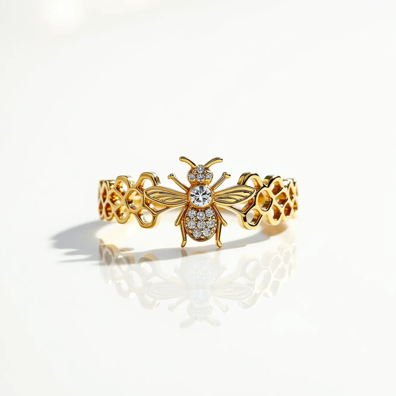 This bee ring is crafted with a gold-toned metal, featuring an intricate bee design at its center. The bee is adorned with small, round-cut clear gemstones, possibly diamonds or cubic zirconia, which are set into the body and wings to add sparkle. The ring's band incorporates a pattern reminiscent of a honeycomb, enhancing the bee motif. The gemstones are prong-set, providing a secure and elegant fit. There are no visible clasps or attachments, suggesting the ring is a complete loop designed to slide onto the finger comfortably.