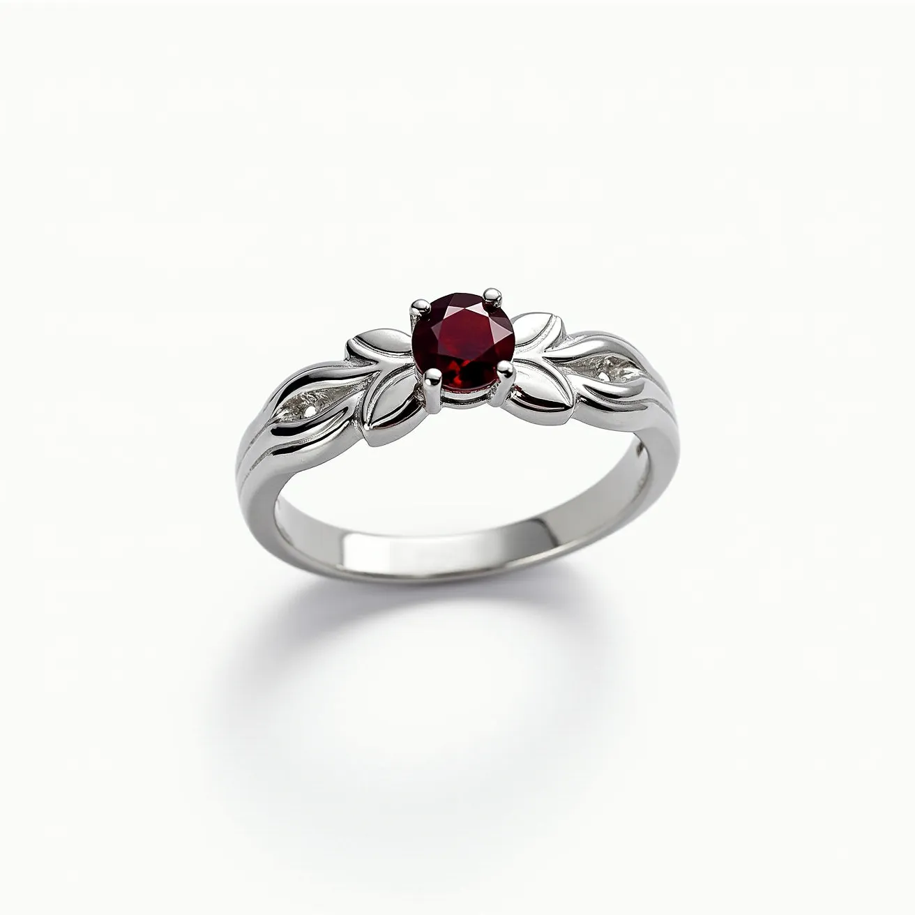 This birthstone ring features a central round-cut garnet set in a prong setting, showcasing its deep red hue. The band is crafted from a polished silver-toned metal, enhancing the ring's overall elegance. The design includes intricate leaf motifs flanking the garnet, each set with a small round diamond, adding a subtle sparkle to the piece. This ring, with its combination of garnet and diamond accents, exemplifies a classic and sophisticated style.