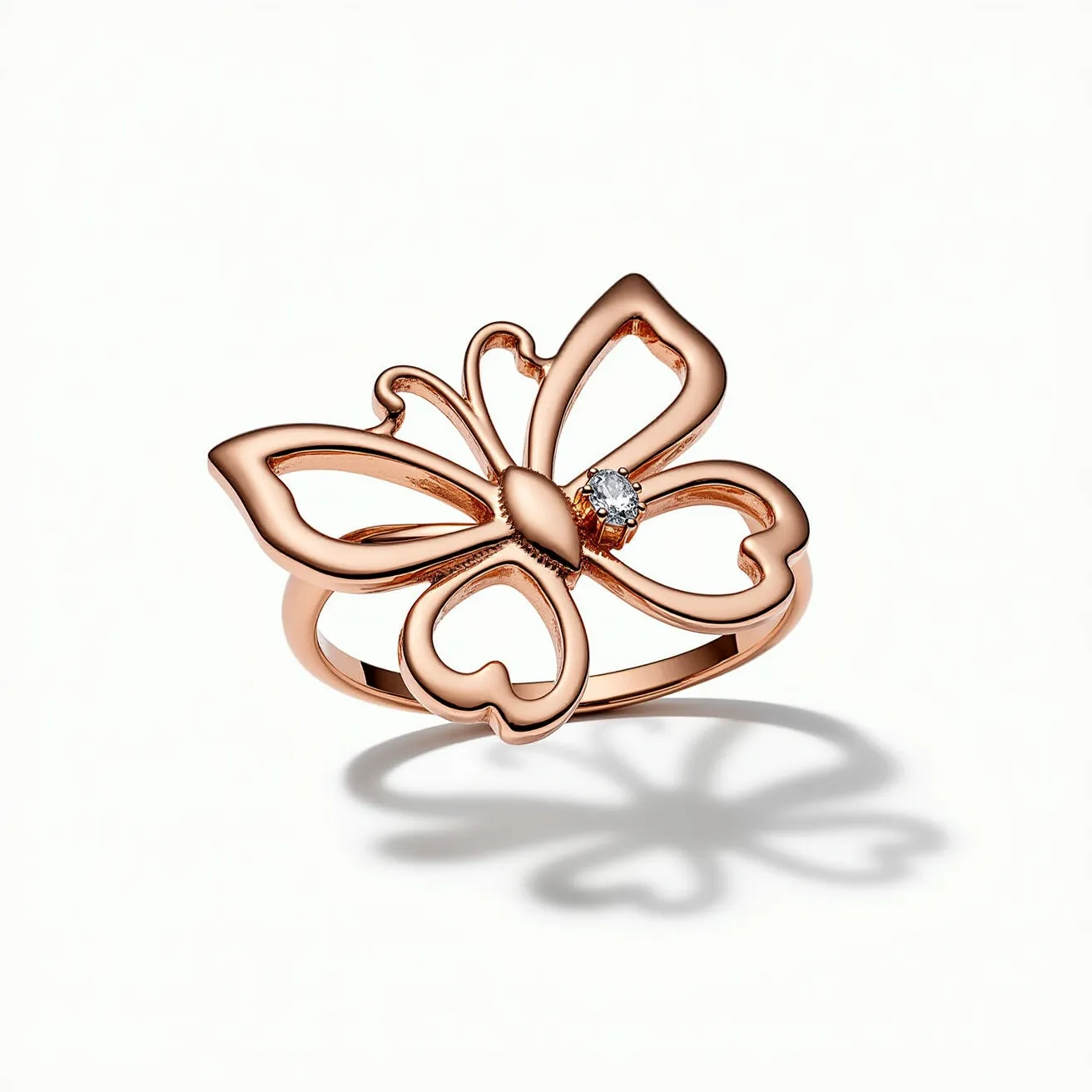 This butterfly ring features a delicate and openwork design, crafted from a polished rose gold metal. The butterfly motif is elegantly outlined, showcasing a whimsical and airy aesthetic. At the center, a small, round-cut diamond is set in a simple prong setting, adding a touch of sparkle to the piece. The band is smooth and continues seamlessly to support the butterfly design, providing a cohesive and elegant look. The ring does not feature any additional clasps or attachments, focusing solely on its central butterfly embellishment.