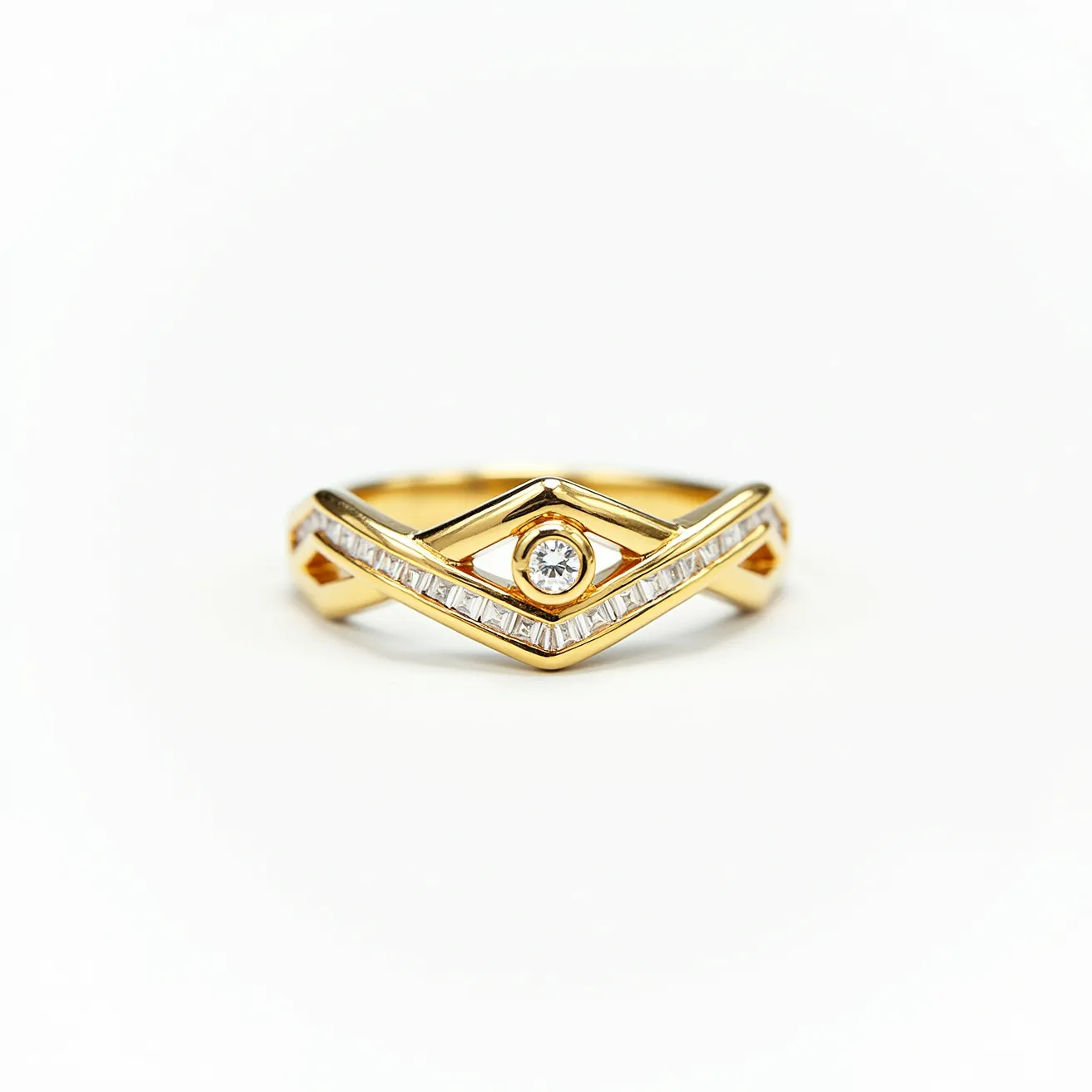 This chevron ring features a sleek design crafted from gold, forming a V-shaped band. The ring is adorned with a central round-cut diamond set in a bezel setting, providing a secure and modern look. Surrounding the focal stone are baguette diamonds, meticulously channel-set along the chevron's edges, adding a sophisticated, linear accent to the piece. The combination of the bright diamonds with the gleaming gold creates a harmonious and elegant aesthetic, perfectly blending contemporary style with classic elements.