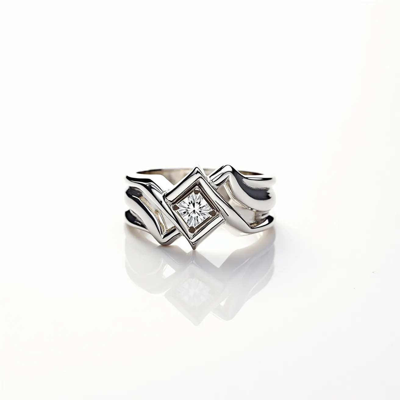 This chevron ring features a striking geometric design with a central diamond set in a bezel setting. The stone appears to be a round brilliant cut, enhancing its sparkle and clarity. The ring is crafted from a polished metal, likely white gold or platinum, which adds to its elegant and sleek appearance. The design of the band incorporates a chevron pattern that complements the angular setting of the diamond, creating a harmonious and modern look. There is no visible clasp or additional attachments, maintaining a seamless and sophisticated aesthetic.