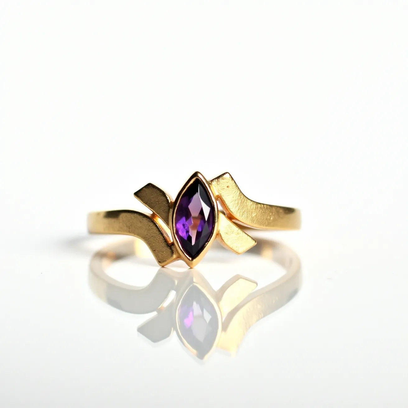 This chevron ring features a sleek design crafted from a polished gold metal band. At its center, the ring showcases a marquise-cut amethyst, characterized by its rich purple hue. The gemstone is secured in a bezel setting, effectively enhancing the ring's modern aesthetic and ensuring durability. The chevron shape of the band elegantly frames the central amethyst, adding to the ring's unique style and charm.