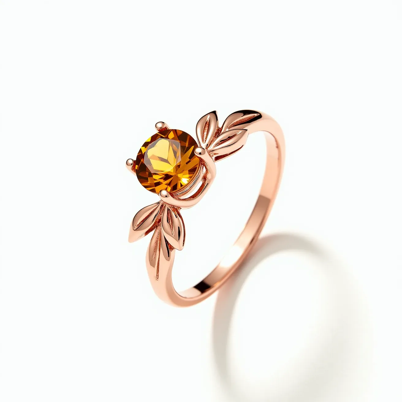 This citrine ring features a vibrant, faceted round citrine gemstone, securely set in a prong setting that showcases its stunning color and brilliance. The setting is adorned with delicate leaf-shaped designs, enhancing its elegance and adding a touch of nature-inspired beauty. The band is crafted from a warm, rose gold-colored metal, complementing the rich hues of the citrine and providing a sophisticated backdrop to the overall design. The craftsmanship highlights both the gemstone and the intricate detailing, making it a standout piece of jewelry.