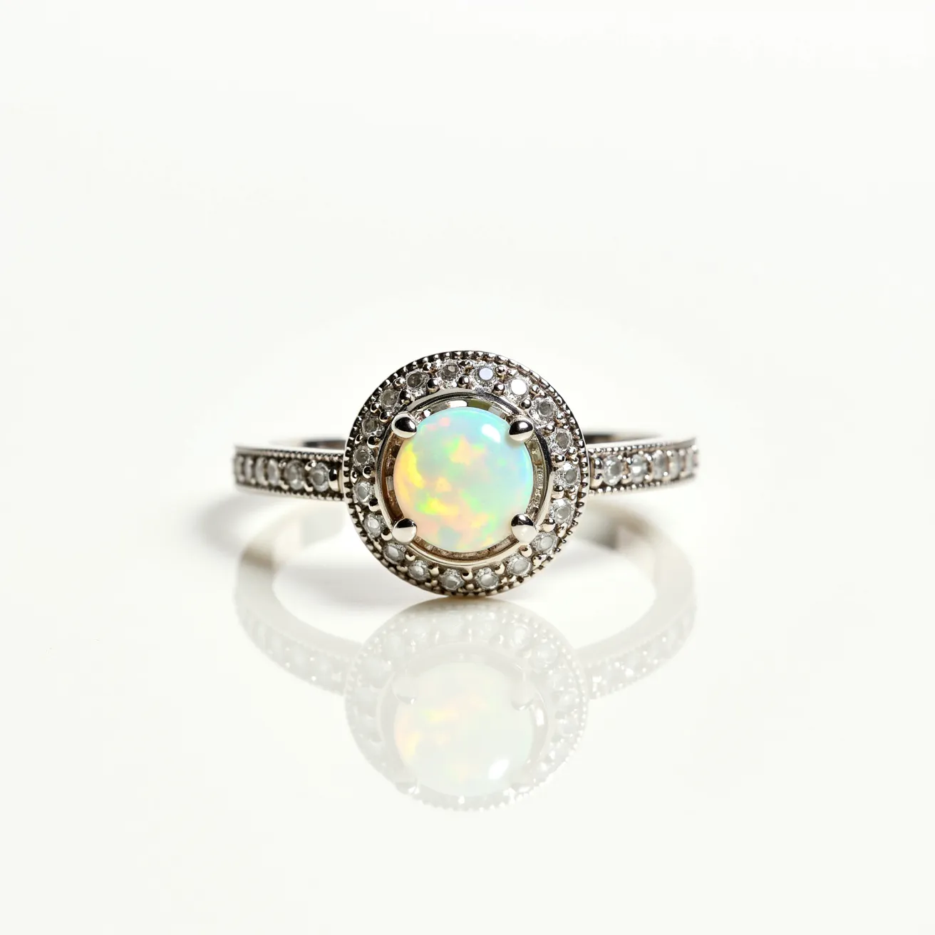 This cocktail ring features a captivating opal as its centerpiece, displaying a mesmerizing play of colors. The opal is round cut and secured by a prong setting, ensuring stability and elegance. Surrounding the opal is a halo of sparkling diamonds, each set in a pavé arrangement that enhances the ring’s brilliance and sophistication. The band is crafted from a polished metal, likely white gold or platinum, providing a sleek and reflective finish. The band is further adorned with additional small diamonds in a delicate row, complementing the central design and adding to the ring’s luxurious appearance.