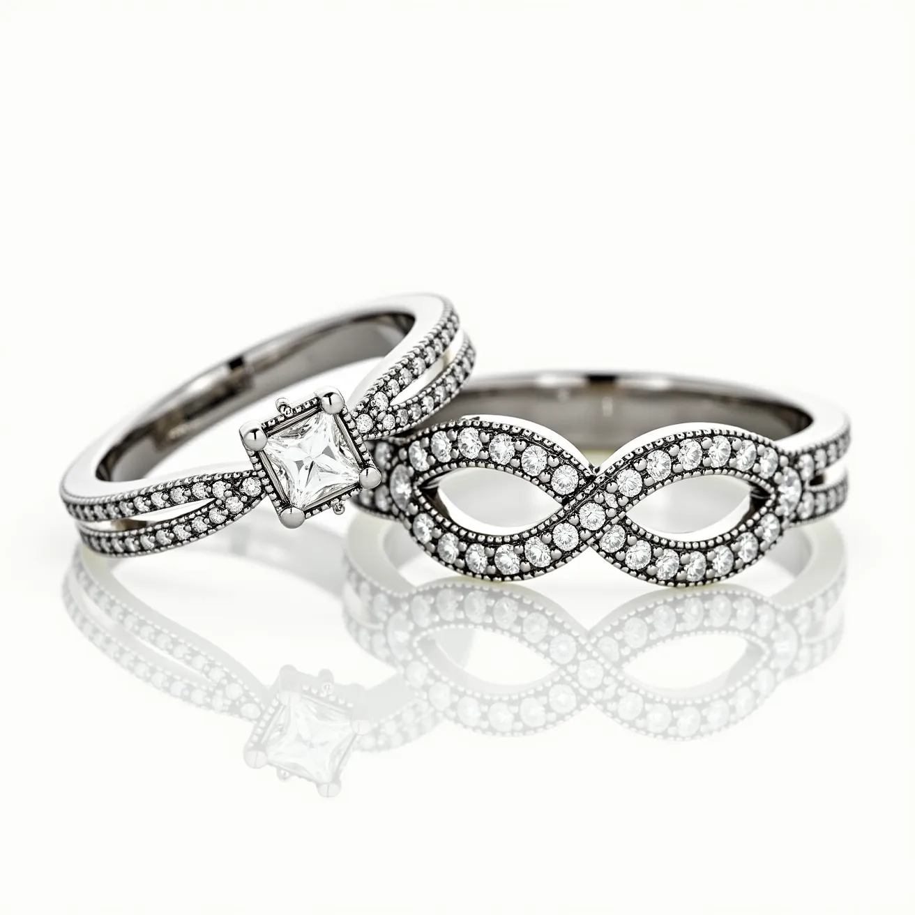 These couple rings are crafted from a silver-toned metal, featuring intricate designs set with numerous small round-cut clear gemstones, likely diamonds or cubic zirconia, which accentuate the bands. One ring showcases a prominent square-cut clear stone held in a prong setting at the center, creating a focal point. The accompanying ring is distinguished by an infinity symbol design encrusted with more of the round stones, elegantly assembled in a pavé setting that enhances its luxurious appearance. Both rings exhibit meticulous detailing, reflecting an elegant and timeless aesthetic.