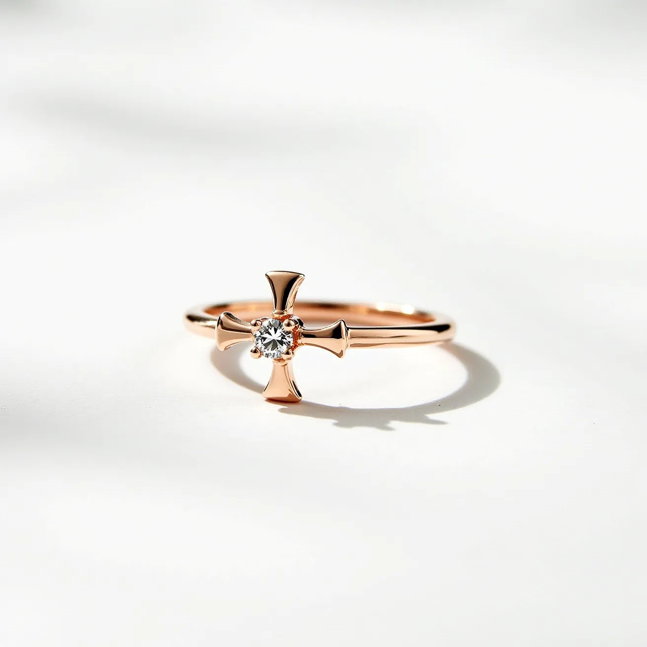 This cross ring features a sleek design crafted from gold, giving it a warm and luxurious appearance. At the center of the cross is a round brilliant-cut diamond, which is securely set in a prong setting, enhancing its brilliance and allowing maximum light to reflect. The cross itself forms part of the ring band, seamlessly integrating into the overall structure and providing a comfortable fit. The design is minimalist yet elegant, making it suitable for daily wear or special occasions.