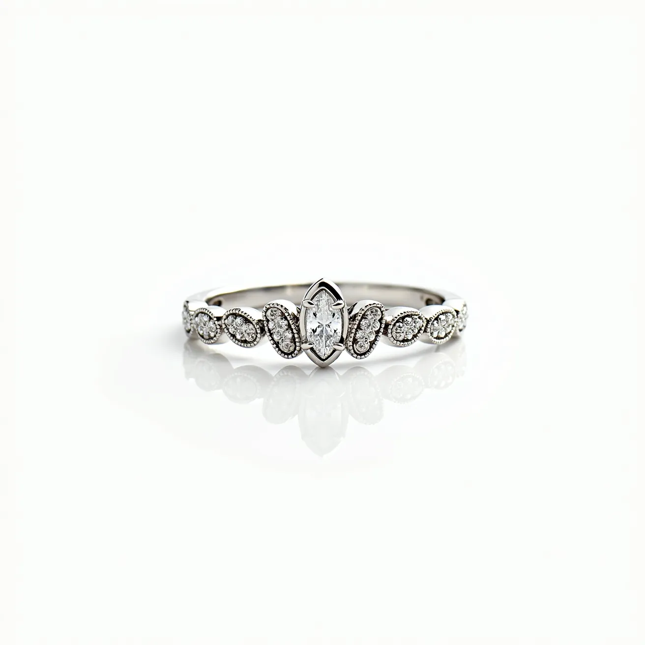 This crown ring features a delicate band crafted from a lustrous white metal, likely white gold or platinum. It is adorned with a marquise-cut central gem that is elegantly prong-set, drawing attention to its elongated form. Flanking either side of the central stone are smaller, round-cut stones, possibly diamonds or cubic zirconia, each securely nestled in a bezel setting. These stones are arranged in an intricate pattern, enhancing the regal aesthetic of the ring. The overall design gracefully mimics the shape of a crown, embodying a sense of elegance and sophistication without the need for additional clasps or attachments.