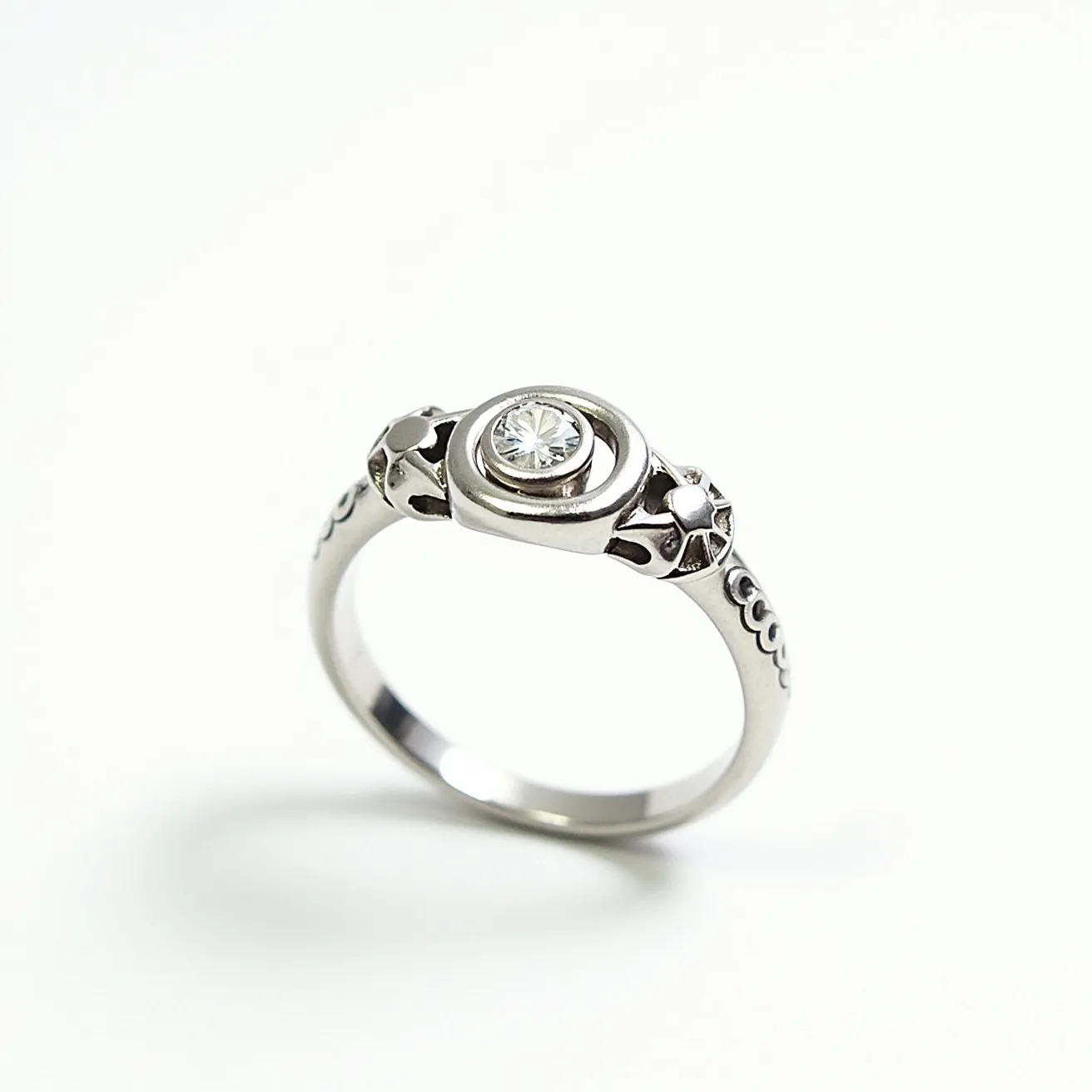 This custom ring features a sleek band crafted from polished silver material. At its center is a round-cut gemstone, likely a diamond, securely held in a bezel setting that complements the ring’s modern aesthetic. The band is adorned with star-shaped embellishments on either side of the central stone, adding a touch of elegance and uniqueness to the design.