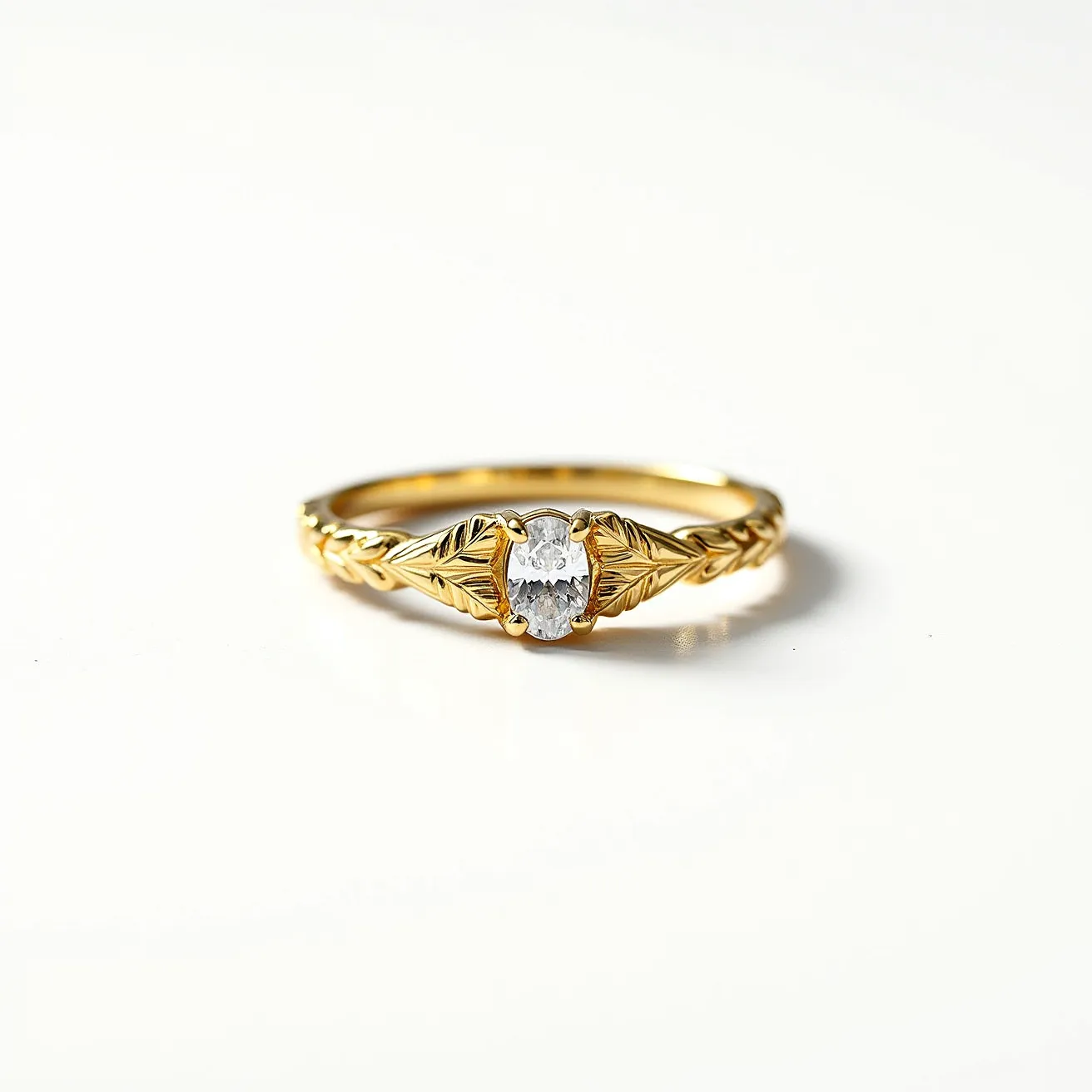 This custom ring features a delicate band crafted from gold, showcasing a finely detailed leaf motif along the sides. At its center, the ring is set with an oval-cut diamond, securely held by a classic four-prong setting. The design emphasizes both elegance and intricate craftsmanship, with the diamond serving as the focal point, beautifully complemented by the richly worked gold band.