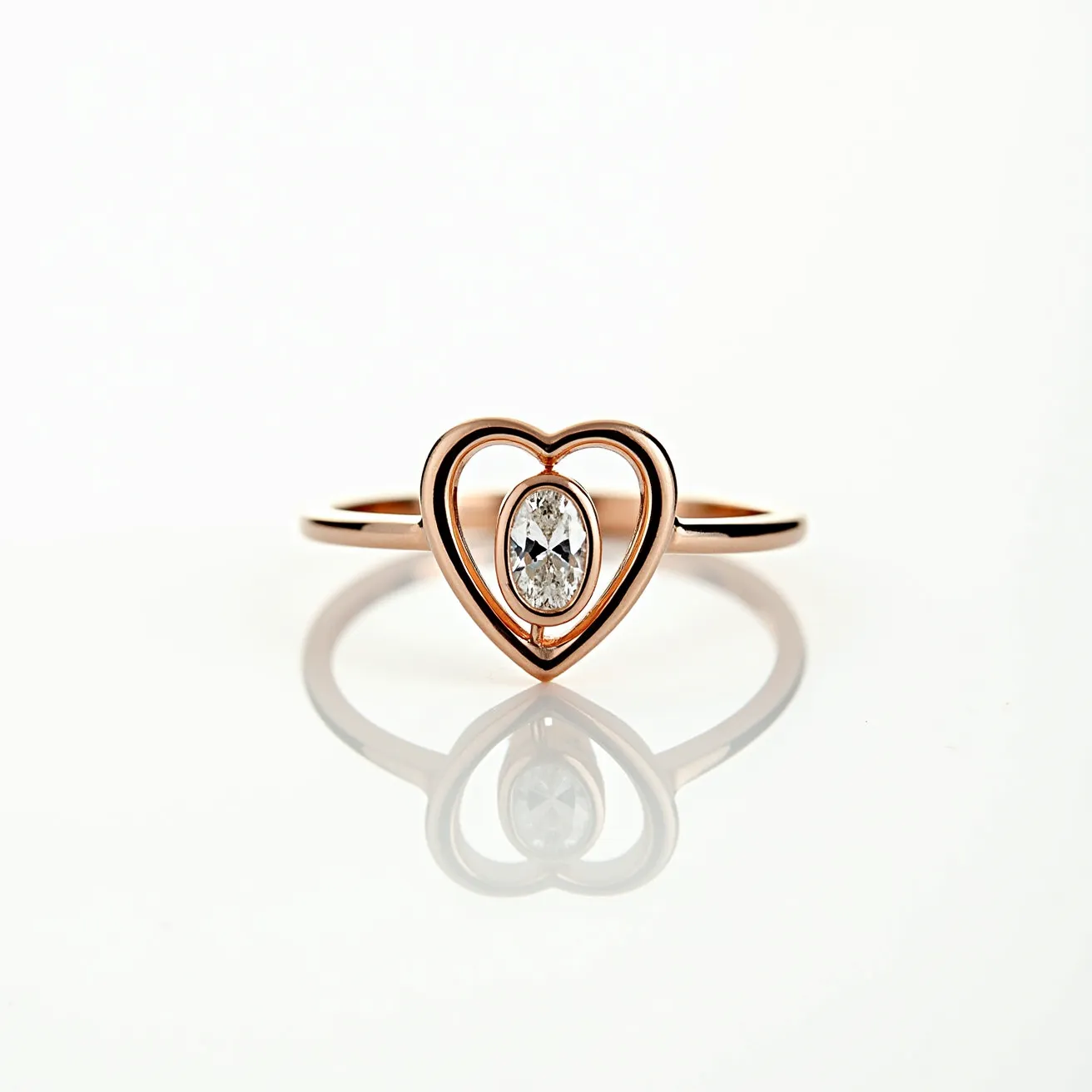 This diamond heart ring is elegantly crafted in rose gold, featuring a sleek band that forms a delicate heart shape at the center. Nestled within this open heart design is an oval-cut diamond, expertly set to catch the light and enhance its brilliance. The diamond's setting complements the minimalist design of the ring, allowing the sparkle of the gem to take center stage. The open heart and diamond combination gives this piece a modern yet timeless appeal.