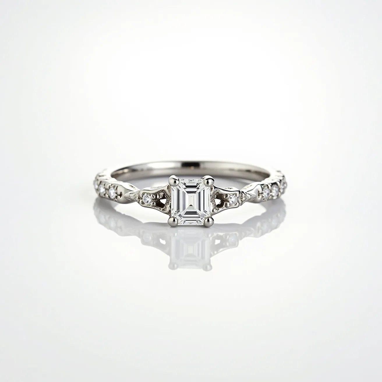 This diamond wedding band features an elegantly crafted platinum or white gold band, enhancing its sophisticated appeal. The center stone is an emerald-cut diamond, secured in a classic four-prong setting, allowing for optimal light reflection and brilliance. Accentuating the central diamond, smaller round brilliant-cut diamonds are set in a delicate leaf-like pattern along the band, adding to the ring’s intricate design. The combination of these materials and settings creates a timeless and luxurious piece, designed to be both elegant and eye-catching.