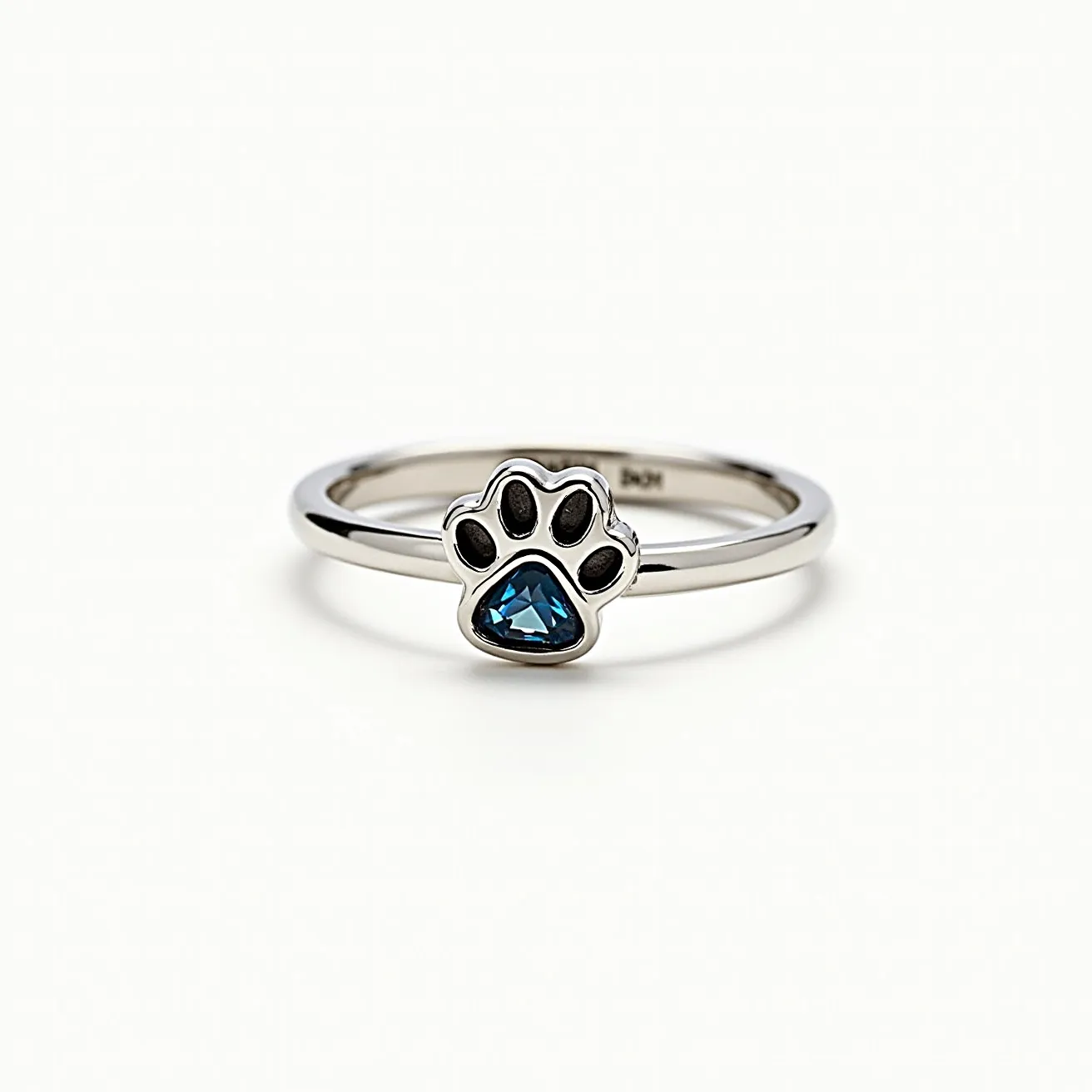 This dog ring features a sleek, polished metal band with a playful paw design at its center. The paw is adorned with a striking blue gemstone, cut in a triangular shape, which is expertly set into the paw's design. The metal of the ring appears to be a shiny silver, complementing the vividness of the blue stone. The setting securely holds the gem in place, highlighting its color and shape without the need for additional clasps or attachments. This design balances elegance and whimsy, making it a unique accessory for dog lovers.