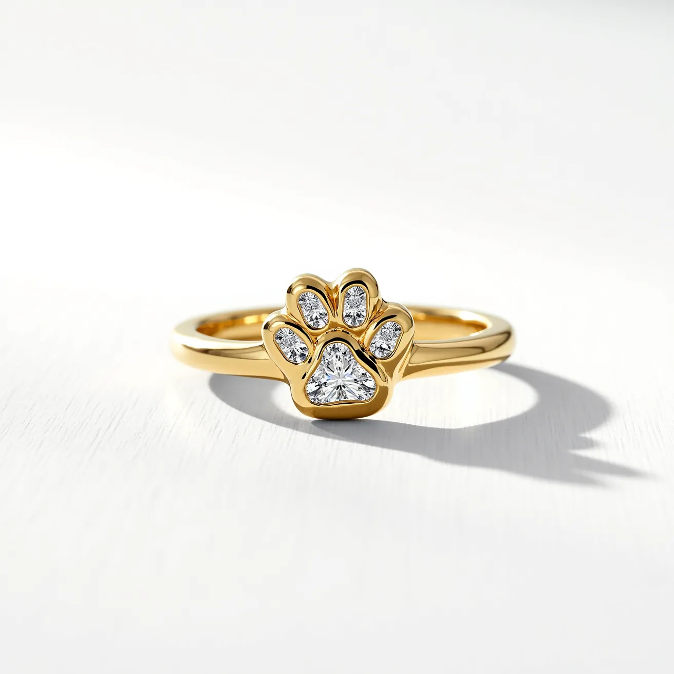 This dog ring features a polished gold band with a charming paw print design at its center. The paw is detailed with clear, sparkling stones, likely diamonds, embedded in a bezel setting, showcasing a skillful arrangement that accentuates each pad of the paw. The diamonds are cut into a brilliant style, providing maximum shine and aesthetic appeal. The overall structure is seamless, indicating that there is no clasp or attachment, designed for a comfortable fit and elegant presentation.