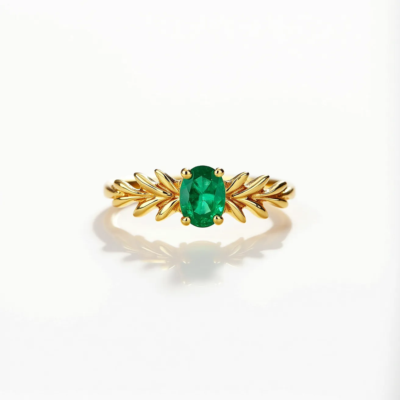 This emerald birthstone ring features a vibrant oval-cut emerald set in a delicate prong setting. The band is crafted from polished gold and is designed with leaf-like details that elegantly flank the central stone, enhancing its natural beauty. The ring does not appear to have any additional attachments or clasps, presenting a seamless and classic design that highlights the stunning gemstone.