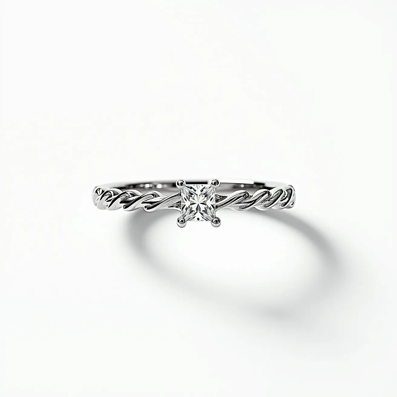 This eternity band ring features a delicate twisted band made of a polished, likely white gold or platinum material, showcasing its elegant craftsmanship. It holds a singular, prominent square-cut gemstone at its center, possibly a diamond, set in a four-prong setting that enhances the stone's brilliance and stability. The ring is designed with continuity in mind, free of any clasps or attachments, symbolizing eternal elegance.