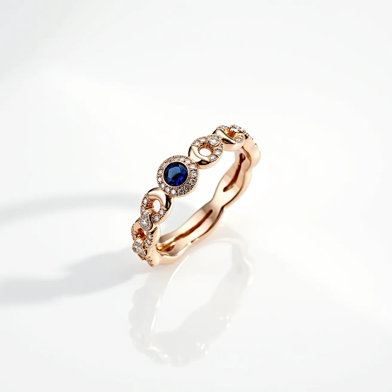 This eternity ring features a gold band adorned with a stunning series of gemstones. The central gem is a round-cut sapphire, prominently displayed in a bezel setting, surrounded by smaller round-cut diamonds. These diamonds are elegantly pave-set, enhancing the ring's luxurious appeal. The band incorporates delicate intertwining patterns that are also embellished with small diamonds, adding to the overall brilliance and elegance of the piece. The ring is crafted meticulously, with the gold band providing a warm and sophisticated backdrop to the dazzling gemstones.