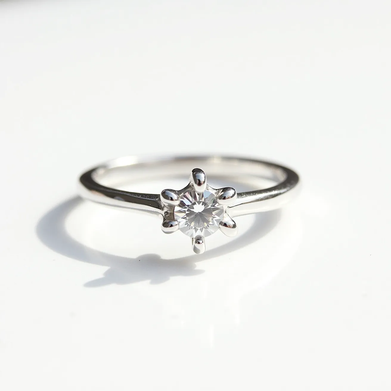 This fidget ring is crafted from shiny metal, showcasing a sleek and minimalist design. It features a central, round-cut gem, likely a clear stone such as a diamond or a cubic zirconia. The gem is elegantly set in a six-prong setting, allowing light to enhance its brilliance and sparkle. The band is smoothly polished, providing a comfortable fit for continuous wear.