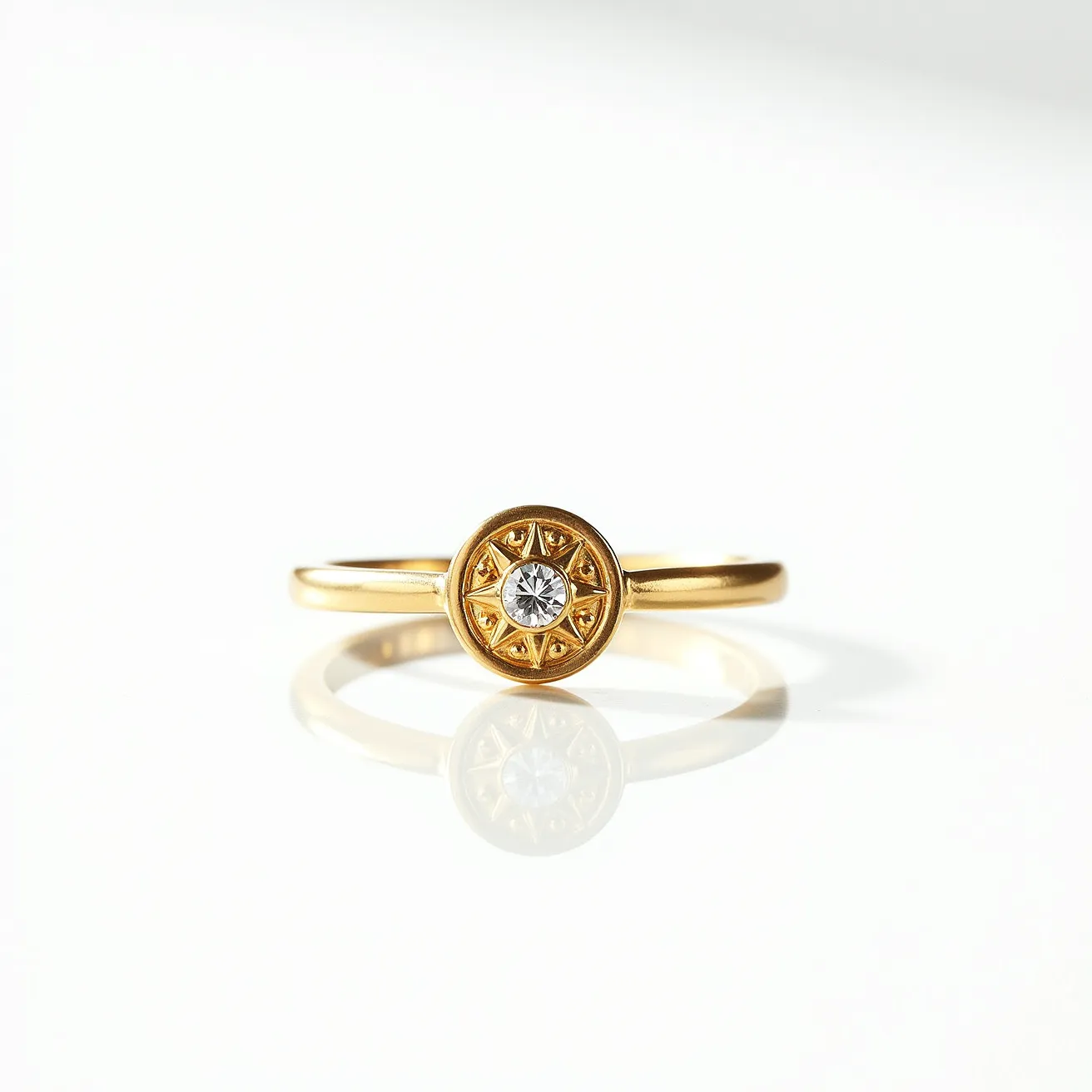 This fidget ring is crafted from gold-toned metal, showcasing a minimalist band that elegantly supports a captivating central feature. The centerpiece displays a small, clear gemstone, likely a diamond or cubic zirconia, faceted in a round brilliant cut. The gem is securely held in place by a bezel setting, encircled by a raised, starburst-like design that adds a touch of intricate detail to the ring. The design and materials suggest a combination of both aesthetic appeal and functionality meant to provide a calming tactile experience.