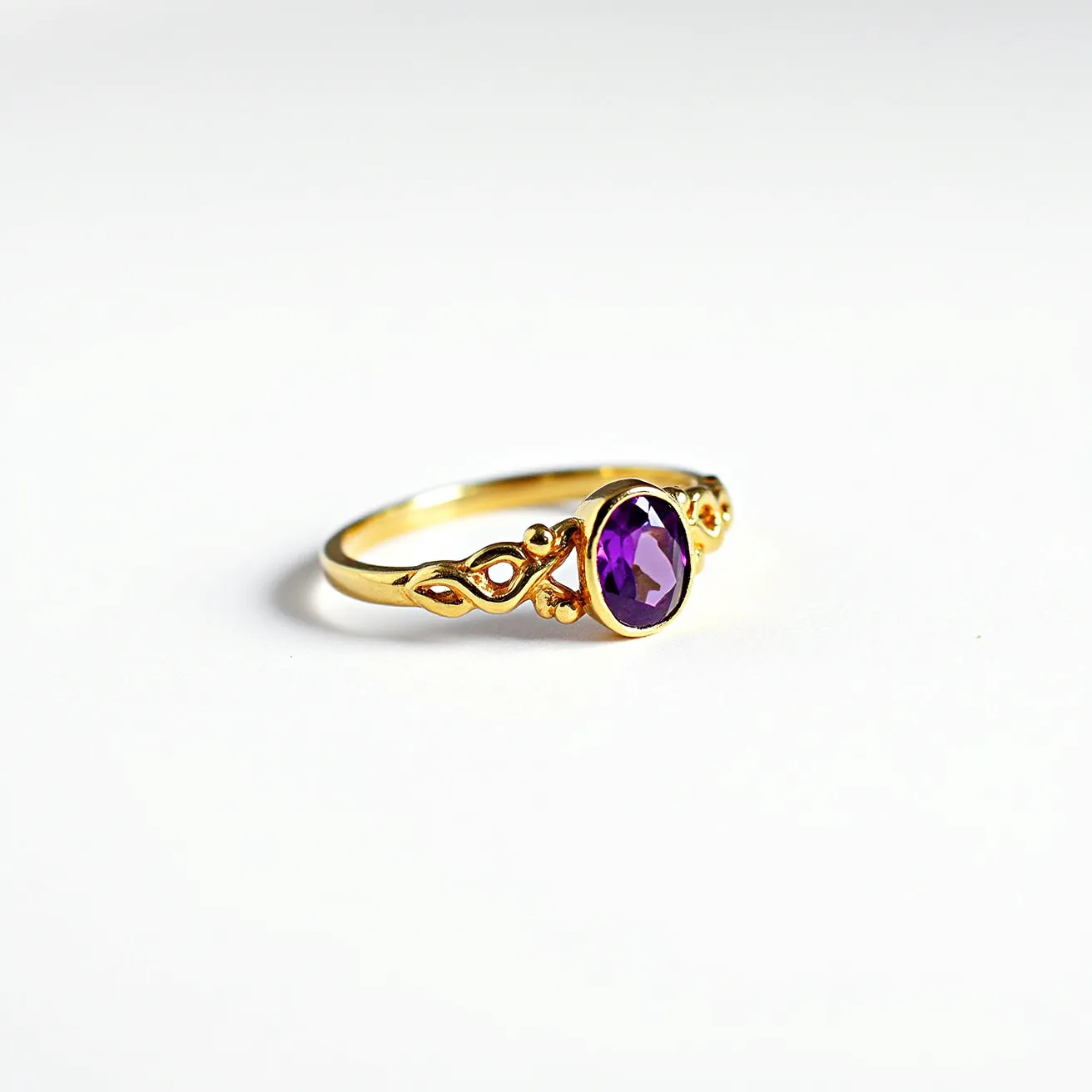 This floral ring features a delicately designed gold band with intricate floral detailing. The centerpiece is an oval-cut purple gemstone, likely an amethyst, set securely in a bezel setting that enhances its luster. The gold material of the band and setting complements the rich hue of the stone, creating a harmonious and elegant appearance. The ring has a seamless design without any apparent clasps or attachments, allowing for a smooth, continuous presentation.