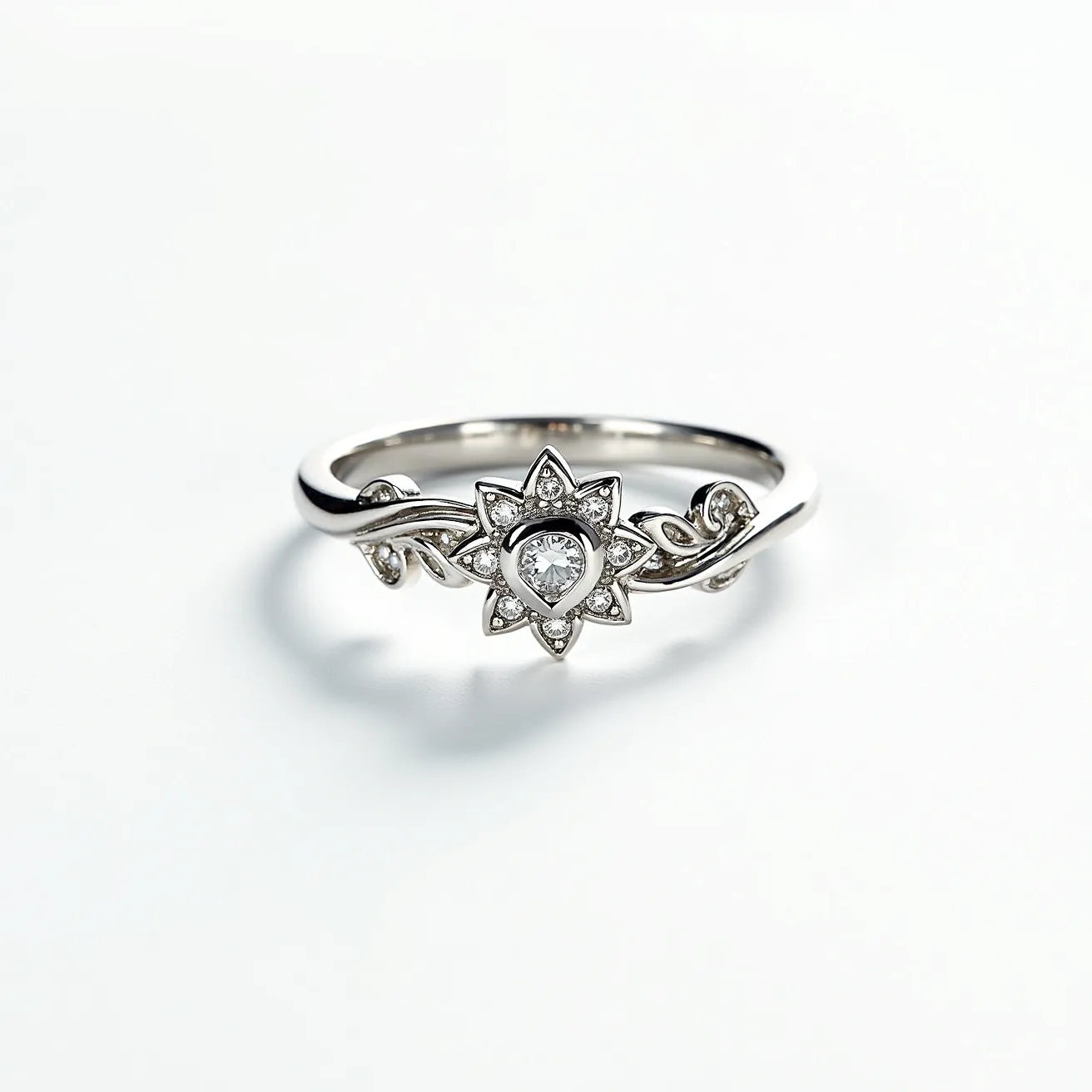 This floral ring showcases an elegant design with a delicate arrangement of materials that suggest likely silver or white gold for the band. At the center, a pear-cut gemstone, possibly a diamond or a clear crystal, is set prominently, surrounded by smaller round stones that create a flower-like motif. The stones are set in a prong setting, enhancing their visibility and sparkle. The band features intricate, vine-like engravings that enhance the ring's floral theme, making it an exquisite piece of jewelry. This ring notably lacks a clasp or attachment as it is a continuous band, typical of rings designed for aesthetic appeal and wearability.