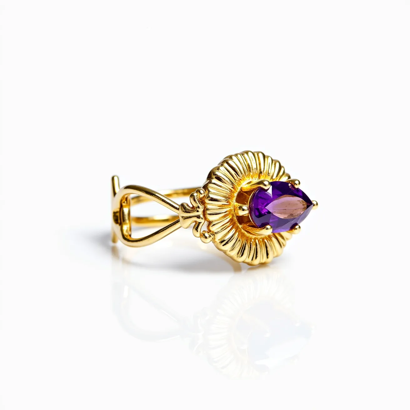 This floral ring features a beautiful purple gemstone, likely an amethyst, with a teardrop or pear cut that adds a touch of elegance and sophistication. The gemstone is centrally set within a gold-colored floral motif, designed to resemble petals radiating outward, enhancing the ring's overall aesthetic and giving it a distinctive, nature-inspired look. The setting securely holds the gemstone with prongs, ensuring it is prominently displayed. The band is crafted in a gold-tone with an intertwining, looped design, providing a unique and intricate structure that complements the floral setting.