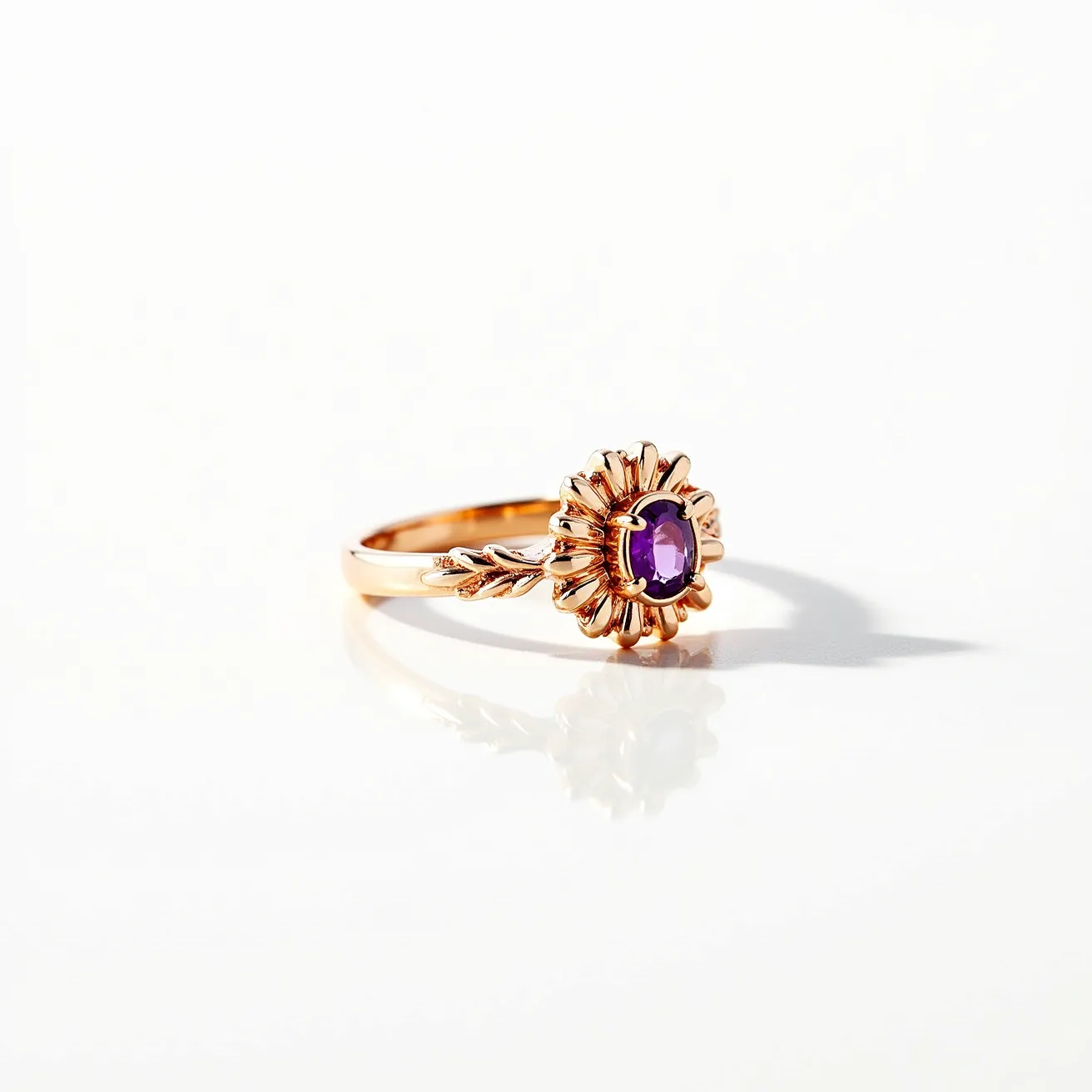 This floral ring features an elegant design crafted from a warm, rose-toned metal that forms the setting and band. At its center rests a vibrant oval-cut purple gemstone, possibly amethyst, securely held in place with a bezel setting that mimics the petals of a flower. The intricate detailing extends into the band which is adorned with leaf motifs, adding to its naturalistic theme. The band seamlessly wraps around the finger without any visible clasps or attachments, emphasizing its refined craftsmanship.