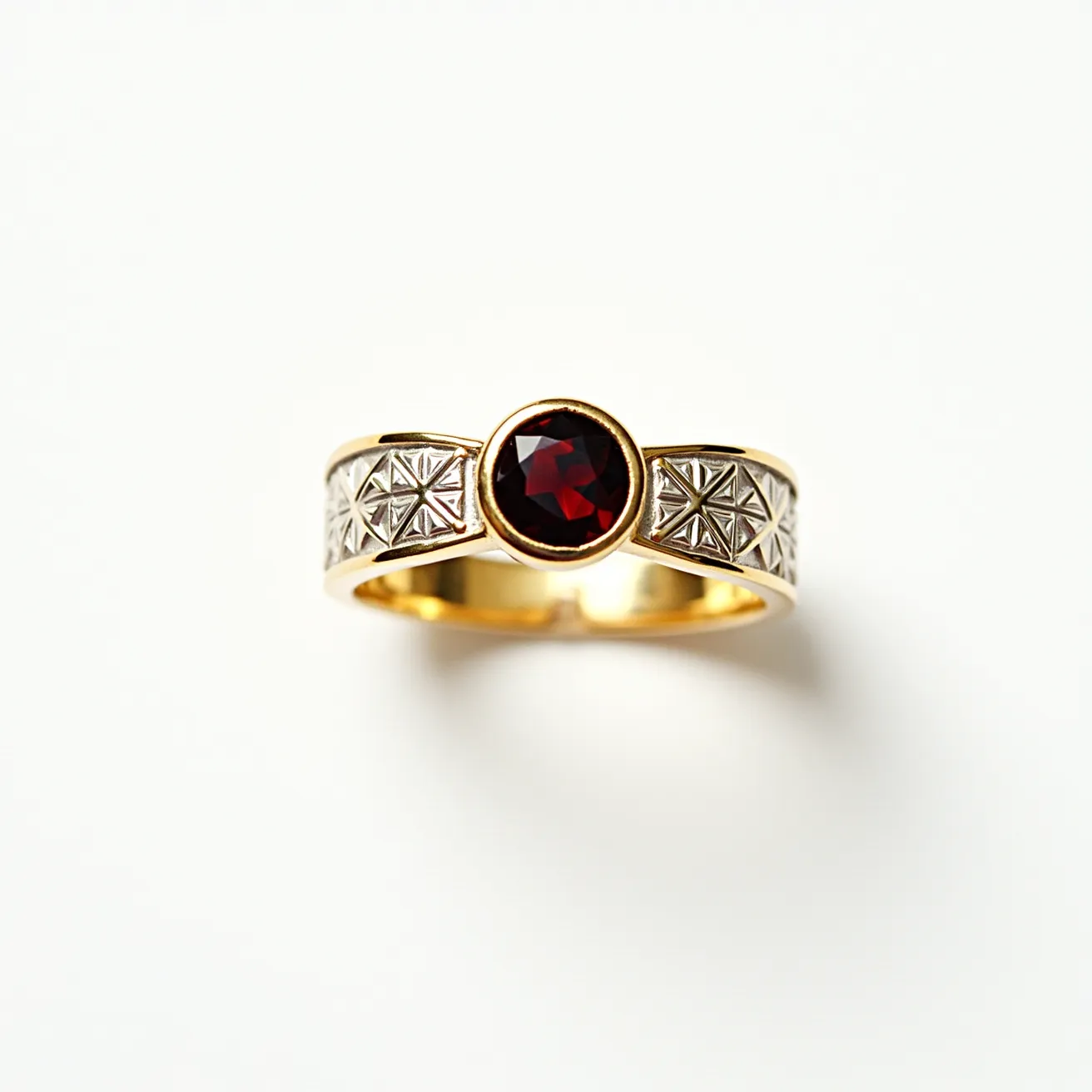 This garnet wedding ring features a striking round-cut garnet as its centerpiece, set in a polished gold band. The garnet is secured by a bezel setting, allowing the deep red hue of the stone to catch the light beautifully. The band itself is adorned with intricate geometric patterns, adding an element of elegance and texture. The combination of the warm gold and the rich garnet creates a classic and sophisticated look, suitable for a timeless and memorable piece.