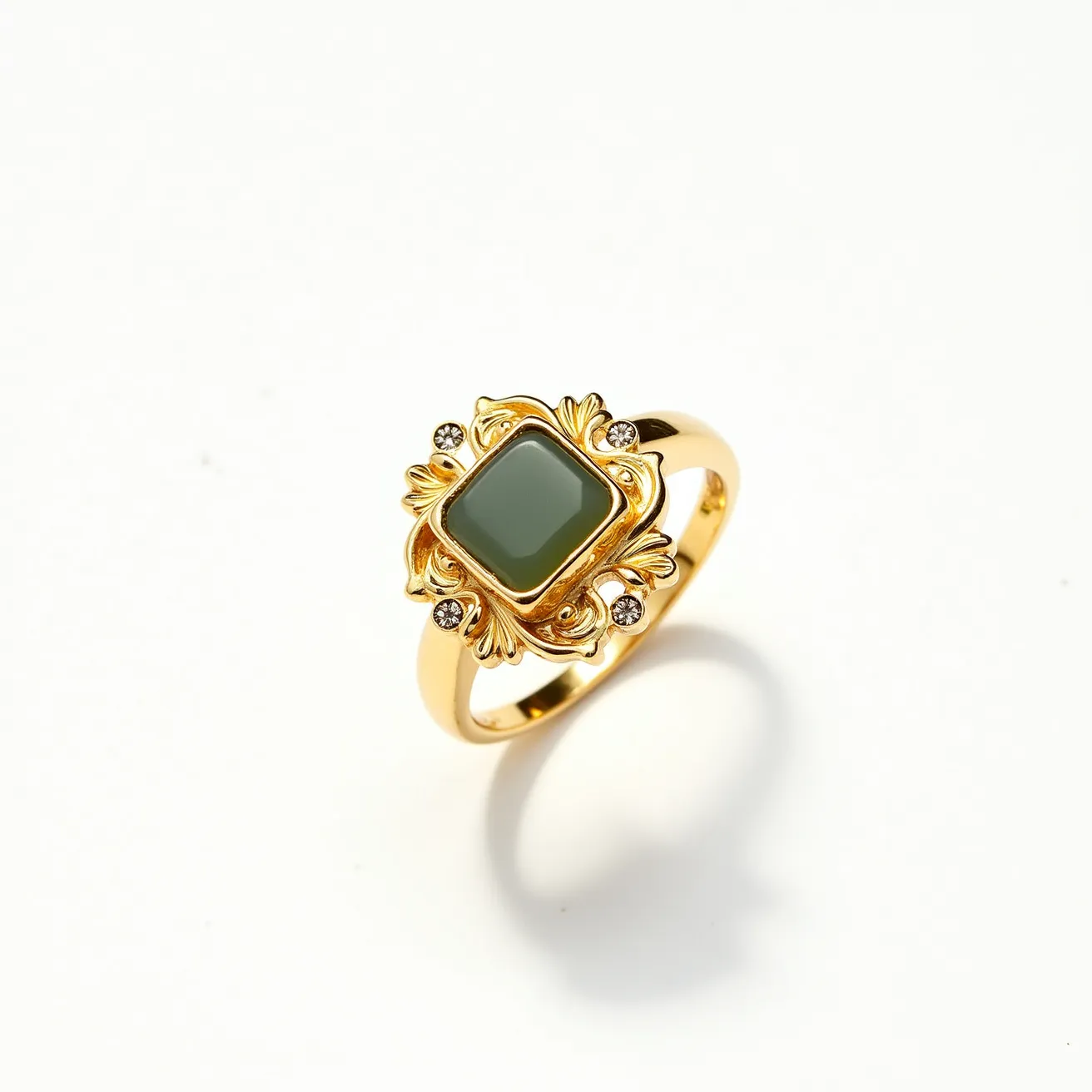 This gemstone ring features a central square-cut green stone, possibly jade or a similar gem, set in an ornate gold setting with intricate leaf-like embellishments. Surrounding the central gemstone, four small round clear stones, likely diamonds or cubic zirconia, are positioned at the corners, adding a touch of sparkle. The band is crafted from polished gold, complementing the decorative motifs and gemstones. The overall design is a harmonious blend of elegance and sophistication, with a rich gold finish that enhances the vivid hue of the central stone.