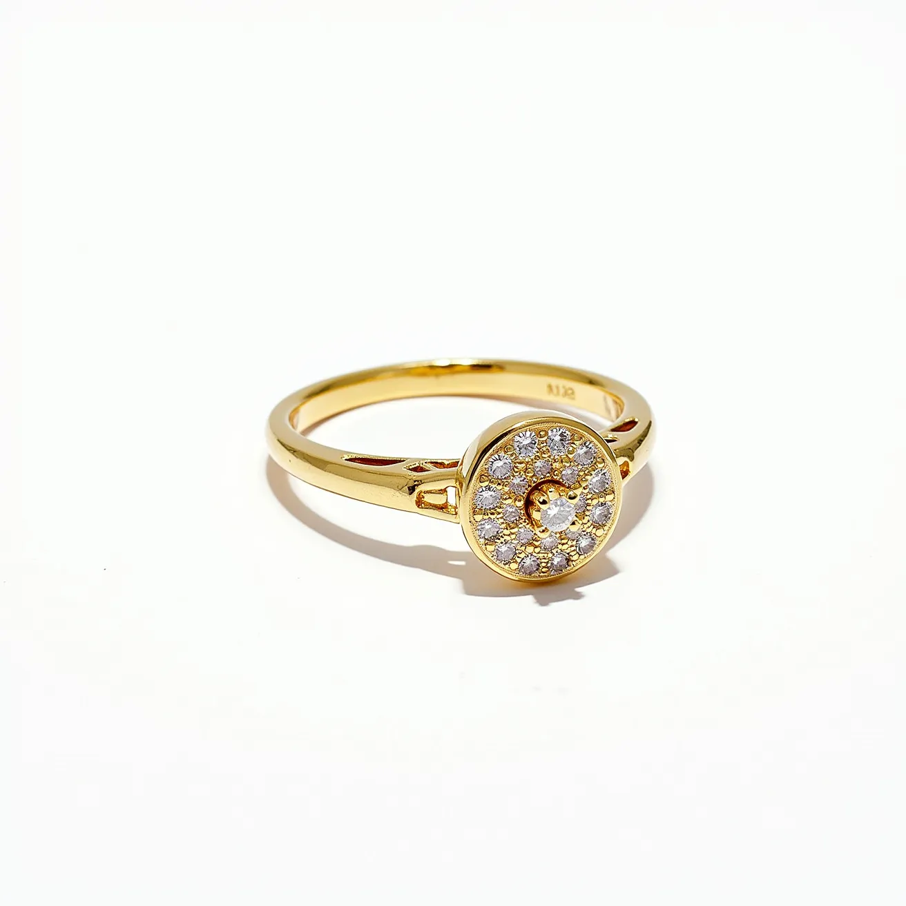 This gold ring features a circular design on its face, adorned with a collection of small, round-cut diamonds arranged in a pavé setting. The diamonds encircle a central gem, collectively creating a sparkling centerpiece. The band itself is crafted from polished gold, which complements the radiant appearance of the diamonds. There are no additional clasps or attachments, highlighting the simplicity and elegance of the ring's design.