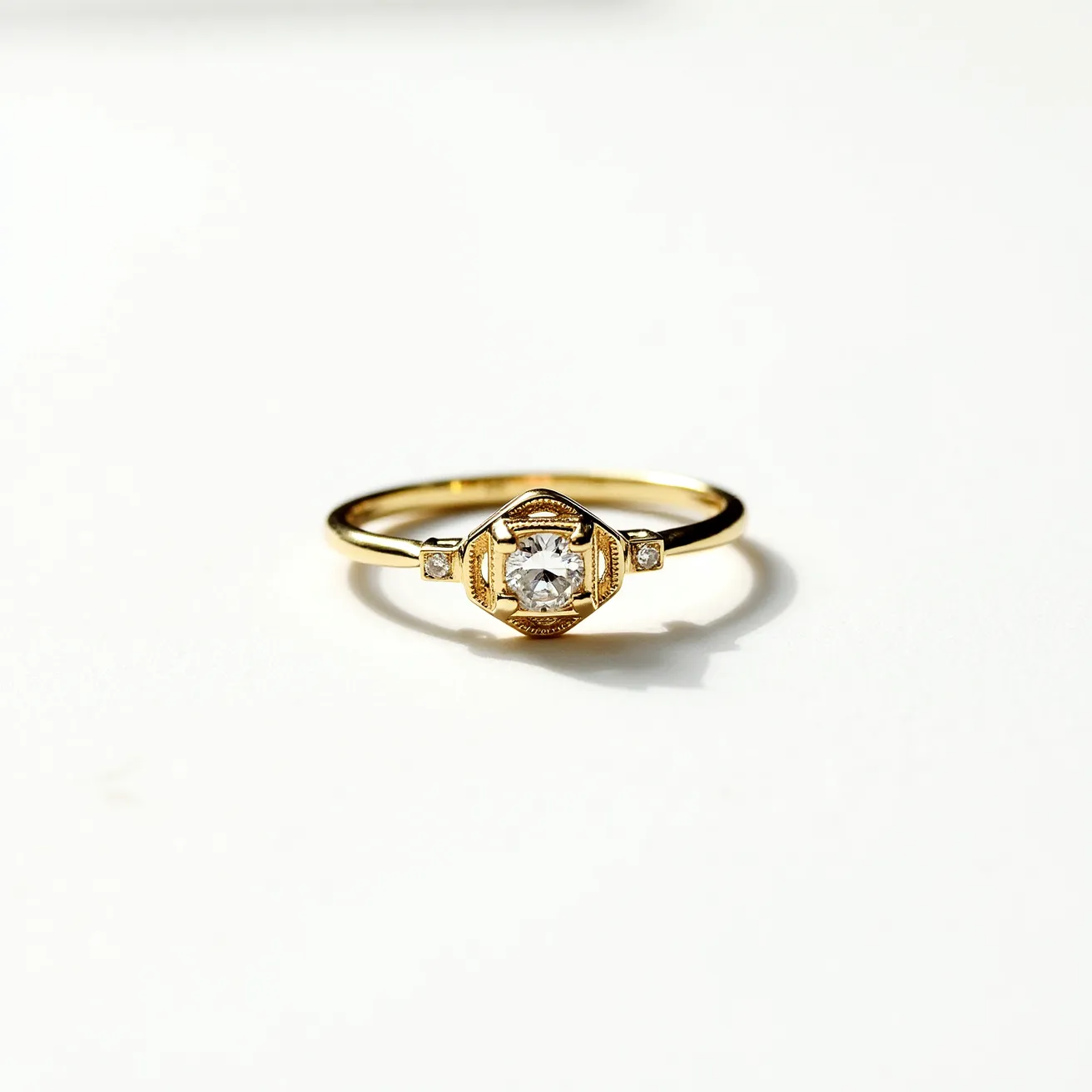 This gold ring features a beautifully crafted design with a gleaming central round-cut diamond securely held in a bezel setting. The band is slender and elegant, highlighting the warm tone of the gold. Flanking the central stone are two smaller square-cut diamonds, each nestled in a subtle setting that complements the overall design. The combination of the precious stones with the polished gold provides an exquisite contrast, enhancing the ring's timeless sophistication.