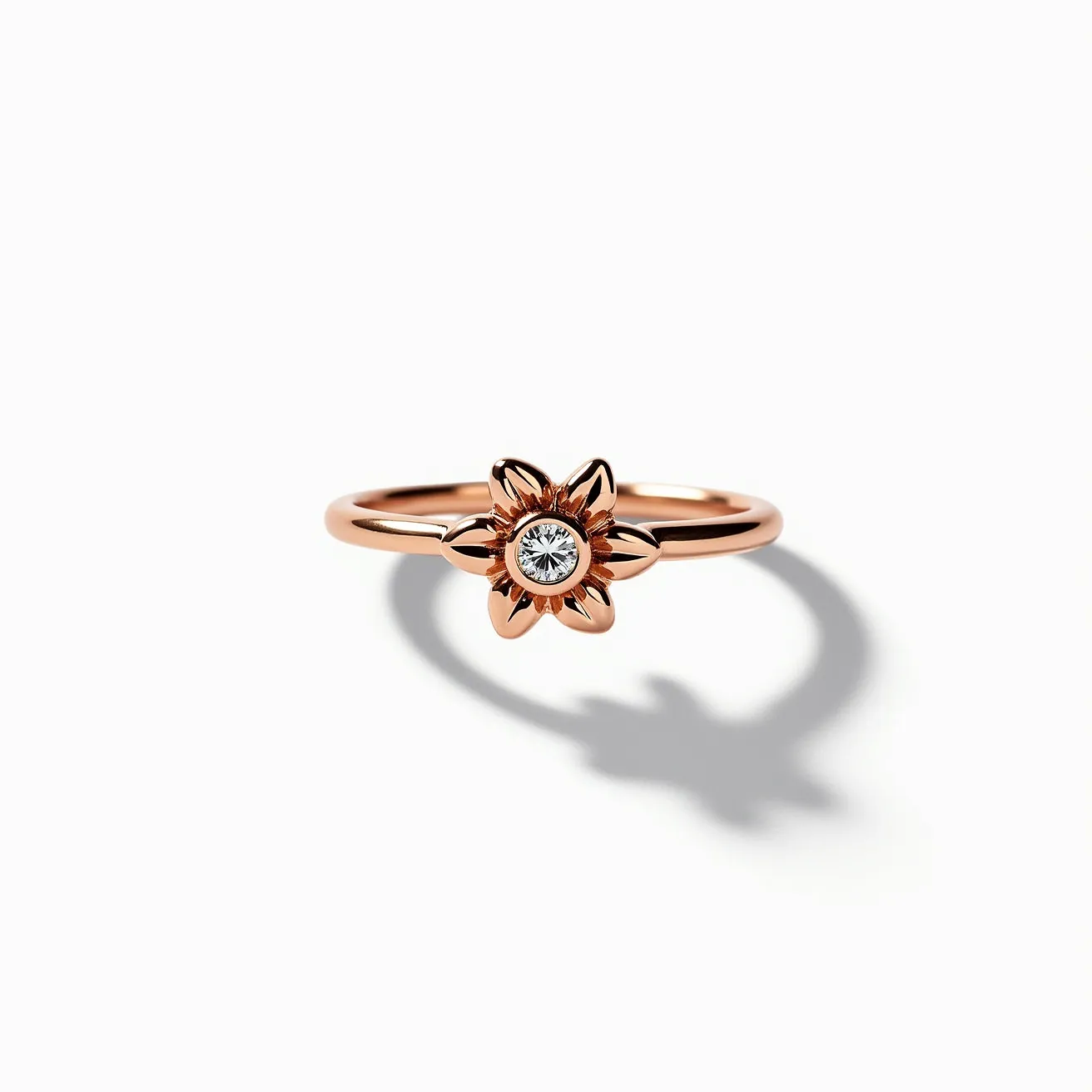 This gold thumb ring features a delicate floral design crafted from gold. At the center of the flower is a round-cut gemstone, likely a diamond, set in a bezel setting that enhances its brilliance and stability. The ring has a simple band with no additional clasps or attachments, emphasizing the elegance of the flower and gemstone combination. The overall design showcases the contrast between the smooth gold finish and the sparkling center stone, making it an exquisite piece of jewelry.