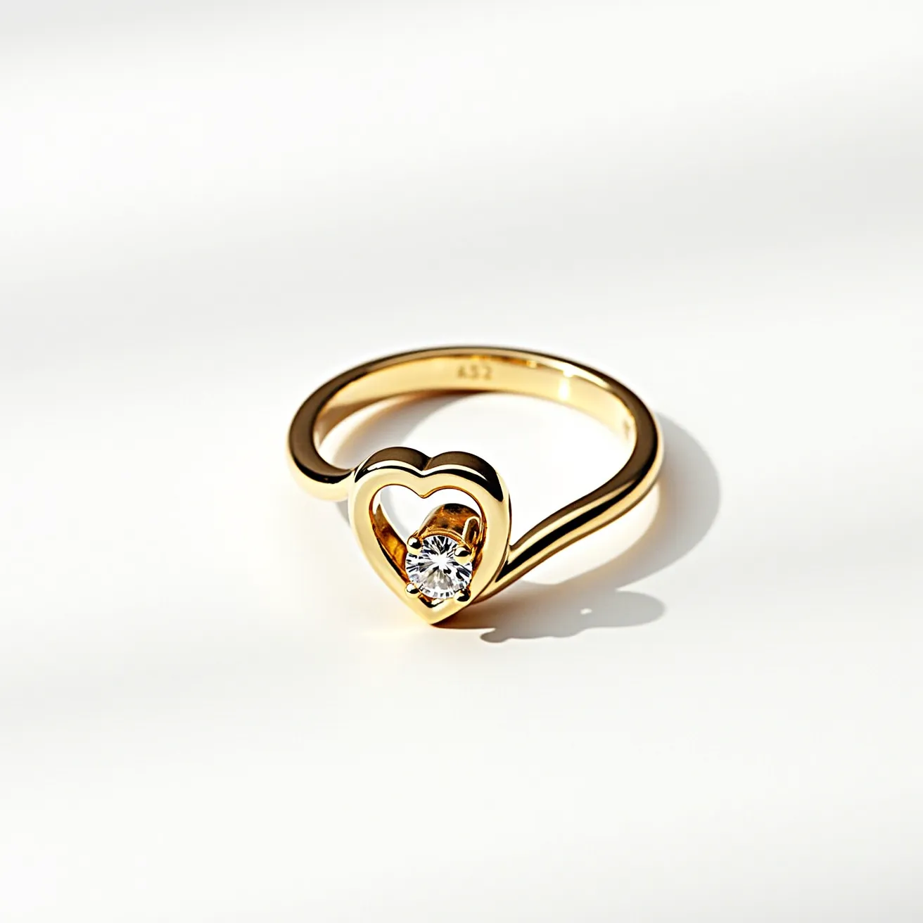 This gold thumb ring features a sleek, polished band crafted from yellow gold, elegantly shaped into a heart design at the top. At the center of the heart, a brilliant-cut diamond is securely set, adding a touch of sparkle to the design. The diamond is held in place with a classic prong setting, which maximizes the stone's visibility and enhances its brilliance. The ring's simple yet elegant structure ensures it's both stylish and comfortable for daily wear.