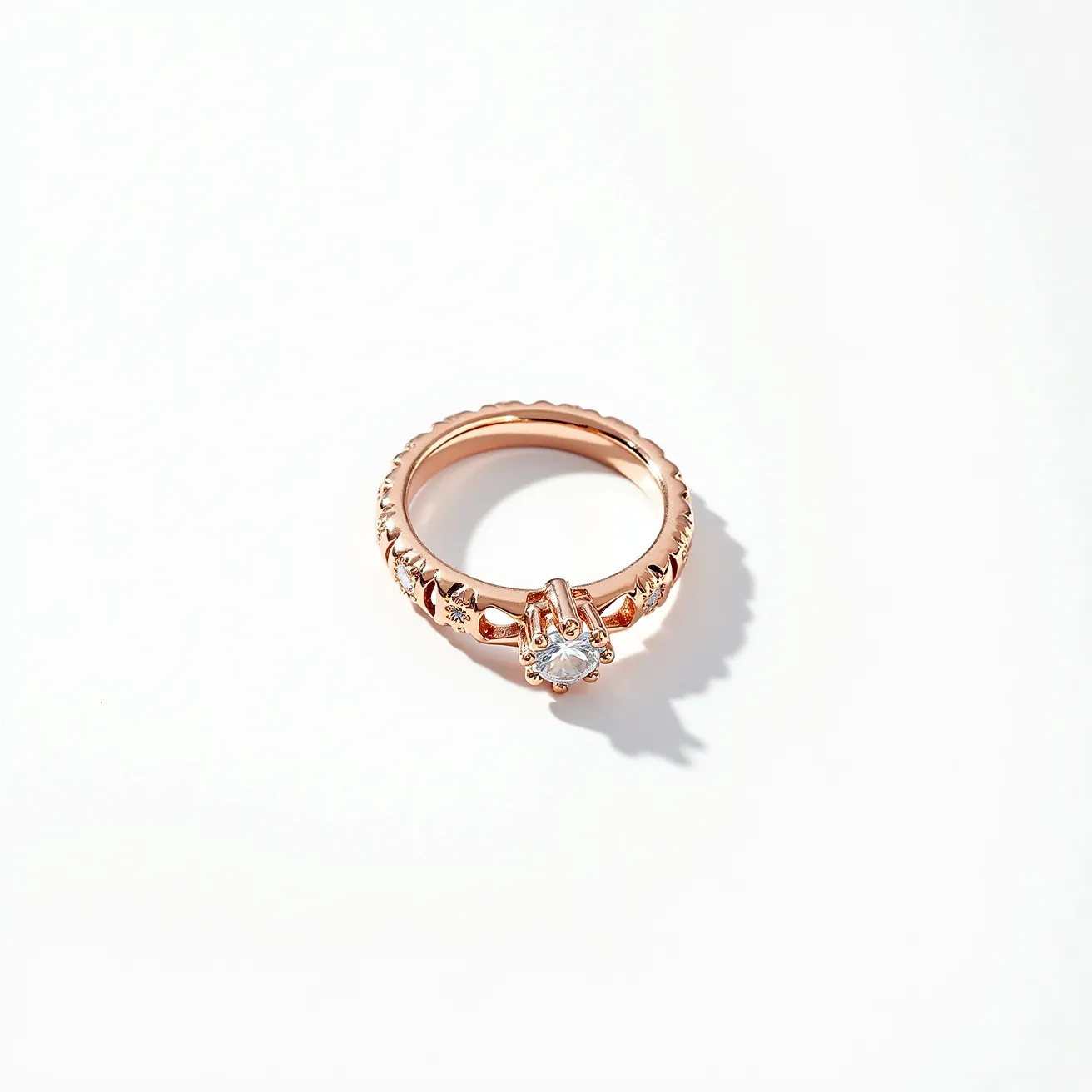 This gold wedding band features a central, round-cut gemstone, likely a diamond, set in a classic solitaire prong setting, which raises and secures the gem above the band. The band is crafted from rose gold, providing a warm and rich hue, and is embellished with intricate detailing, adding texture and elegance to the design. The absence of clasps or attachments emphasizes the continuity and simplicity of the band, focusing attention on the brilliance of the gemstone and the craftsmanship of the gold.