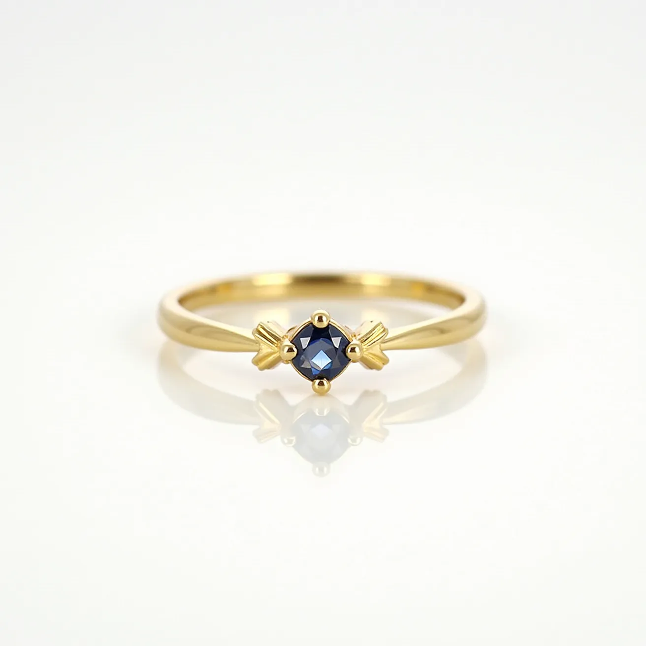 This gold wedding band features a delicate, round-cut blue gemstone set in the center. The gemstone is securely held in place by a prong setting with distinctive, decorative elements on either side that resemble arrows pointing inward. The band itself is made from polished gold, giving it a sleek and classic appearance. There are no visible clasps or attachments, suggesting a continuous design typical of traditional wedding bands.