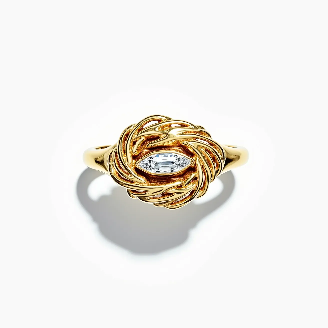 This golden bird ring showcases a vivid yellow gold construction, intricately designed to mimic the texture of feathers, forming a nest-like structure. At the center, it features a prominent marquise-cut gemstone, securely set in a bezel setting which enhances its elegance. The smooth, polished band complements the detailed top, creating a harmonious balance between simplicity and opulence. The overall craftsmanship highlights the luxurious appeal and intricate detailing expected in high-quality jewelry.