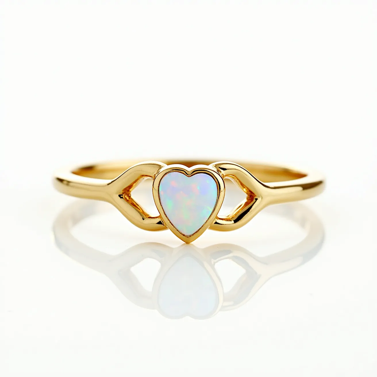 This heart promise ring features a delicate opal gemstone, cut into a heart shape, set at the center of a polished gold band. The opal's iridescent play of colors adds an ethereal touch to the piece. The stone is secured with a bezel setting that emphasizes its unique shape and gleaming surface. The gold band elegantly curves around the opal, with symmetrical open-heart motifs flanking the stone, enhancing the romantic theme of the ring. These design elements create a harmonious and stylish symbol of commitment.